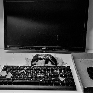 black and white photo of messy keyboard and controller