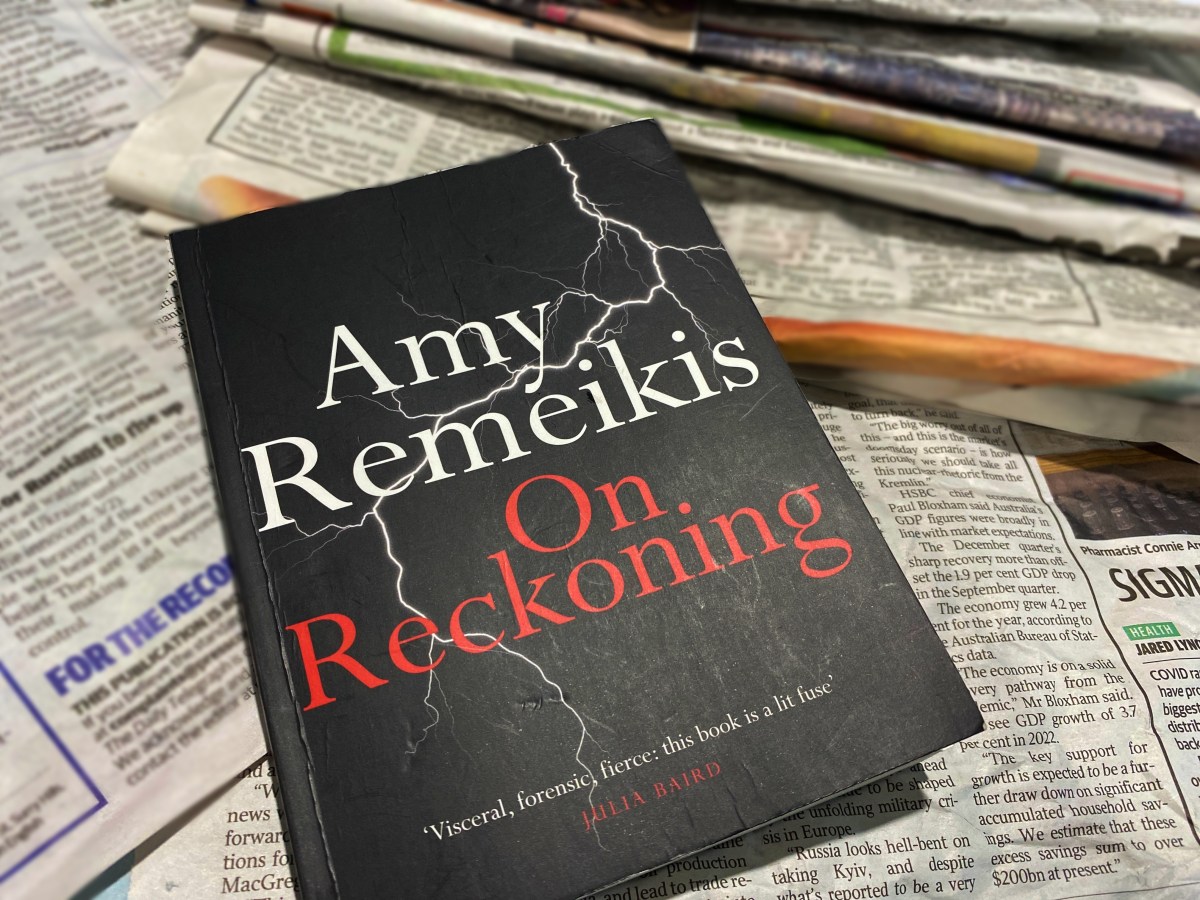 A copy of Amy Remeikis' 'On Reckoning' surrounded by newspapers