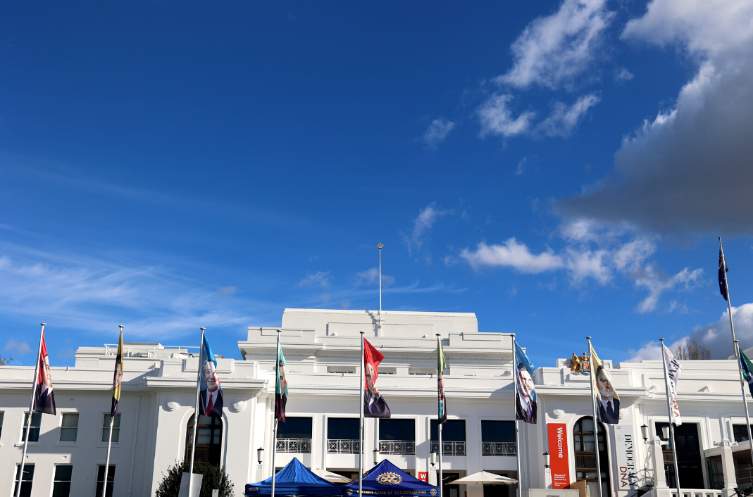 The front of Old Parliament House against a bright blue sky