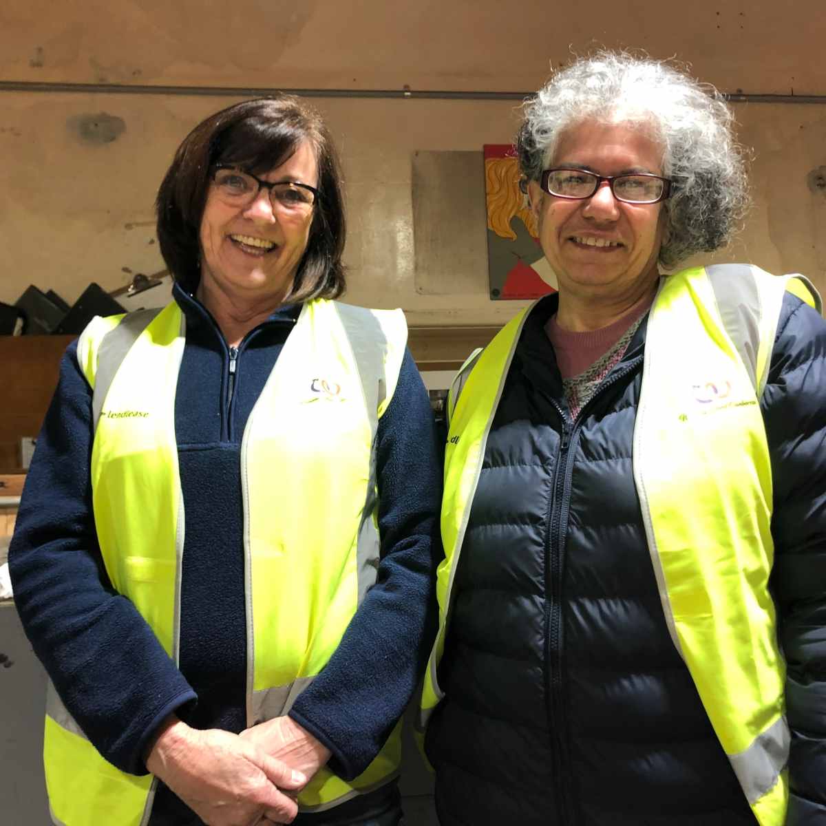 Women's Shed founders Sunita Kotnala and Roby McGarvey standing side by side in high vis vests