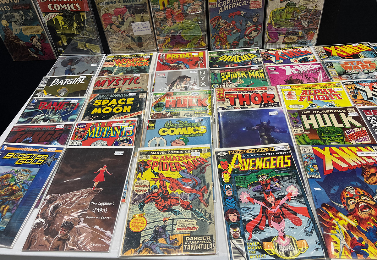 Many different comics laid out on a table 