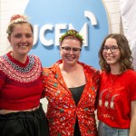 Maddi, Lila and Tia posing in the UCFM studio wearing bright red Christmas clothes