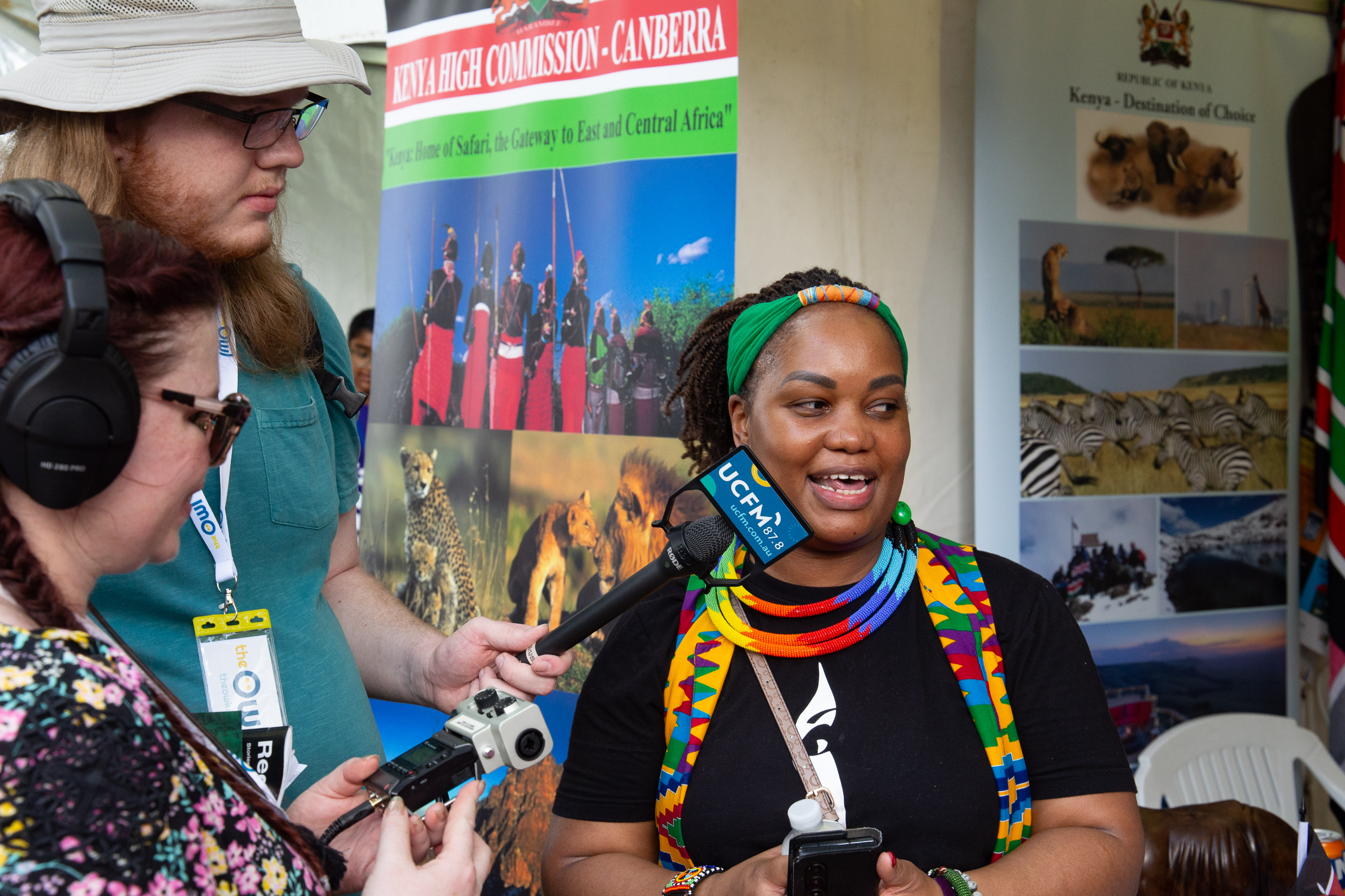 Ben and Lila interviewing a representative from the Kenya stall