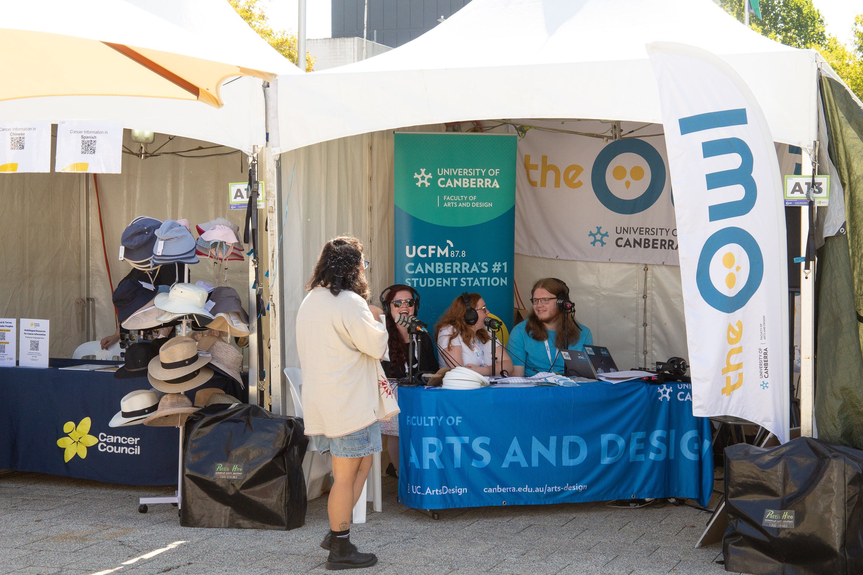 Students broadcasting live from inside The Owl stall