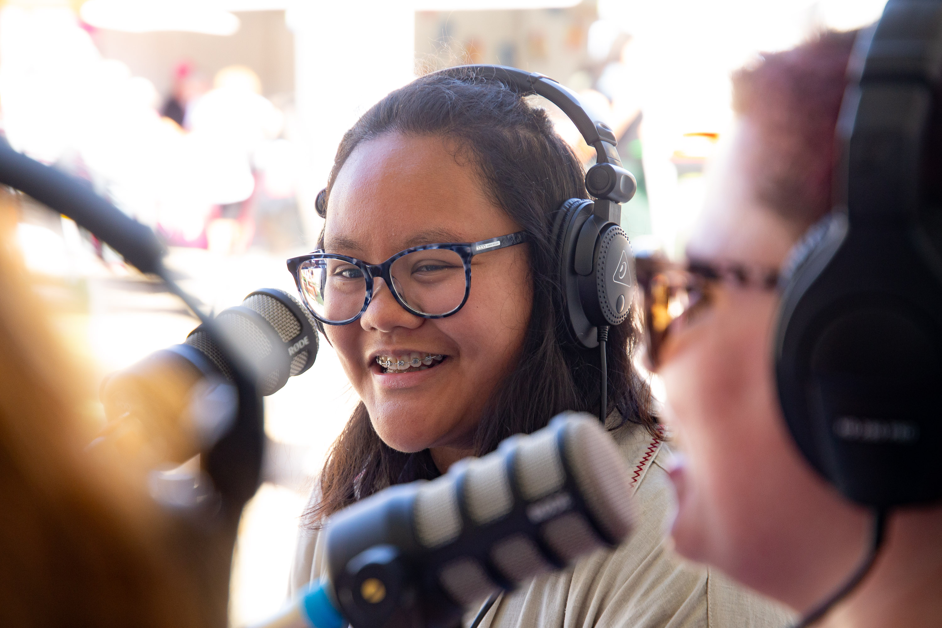 AJ smiling behind the mic