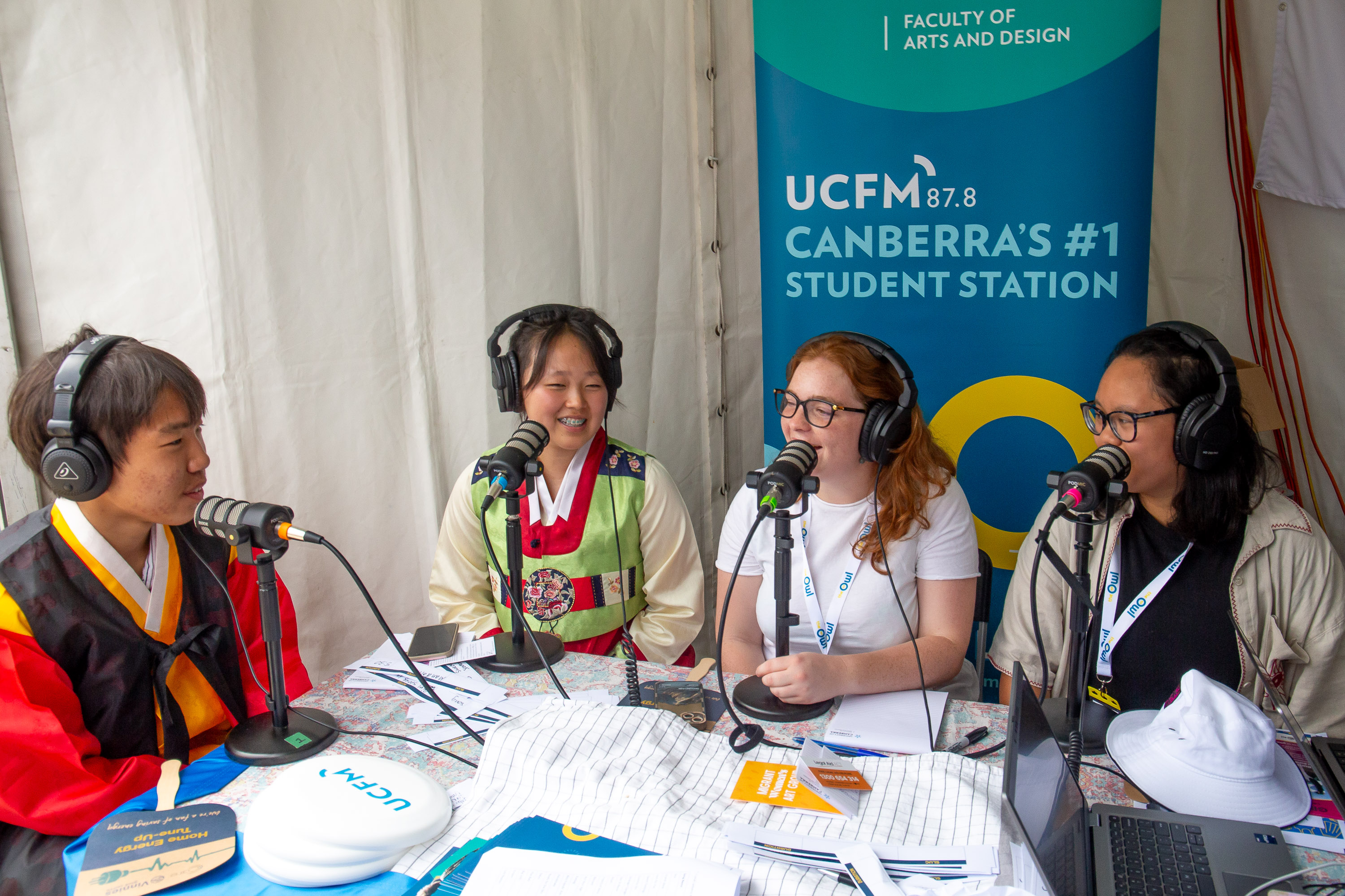 Molly and AJ interviewing two representatives from the Korea stall