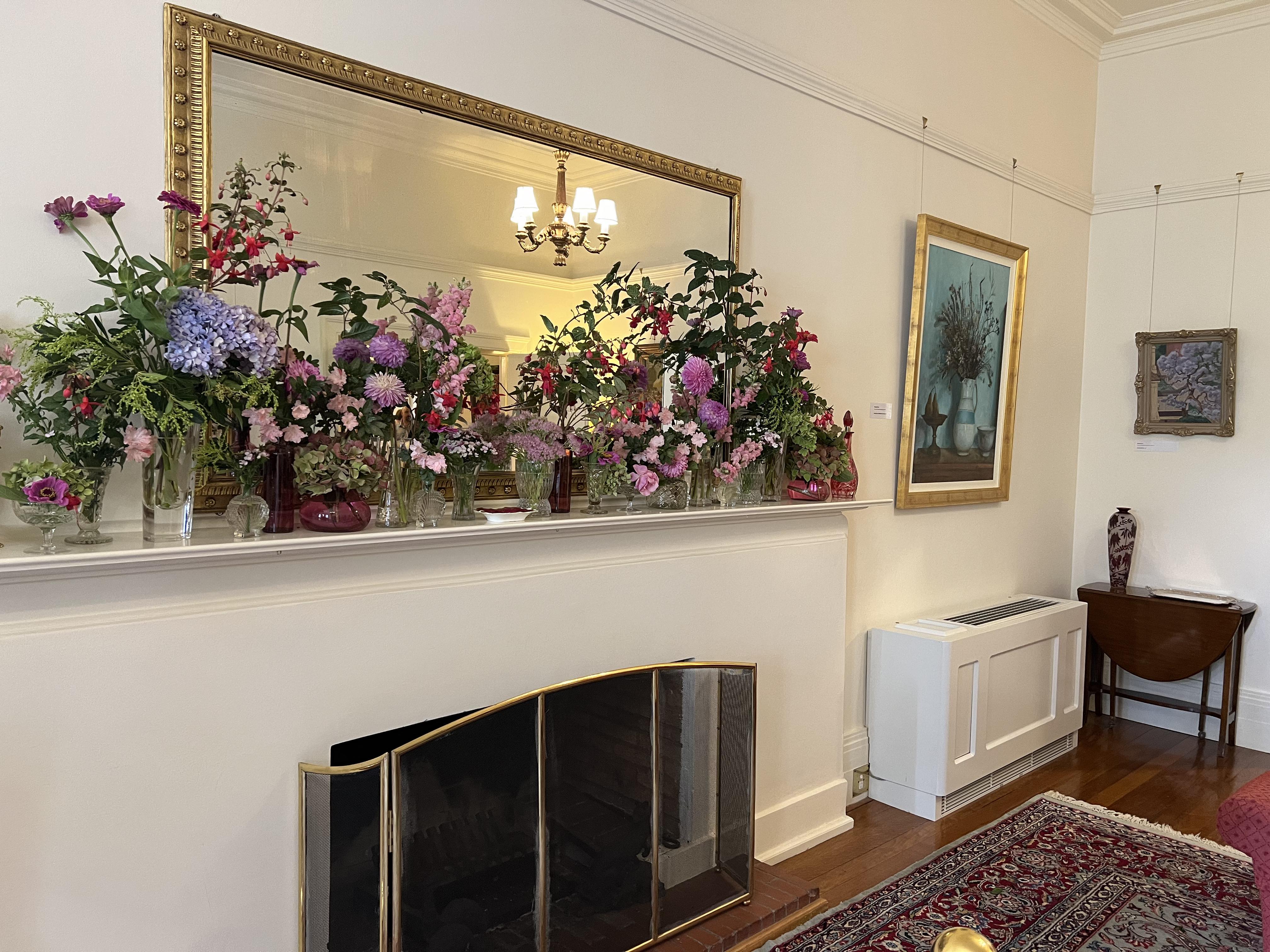 Fireplace place in the sitting room, with the array of flowers displayed. 