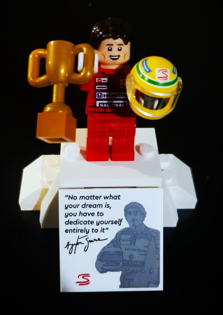 Senna's Lego Figurine featuring a trophy and his race helmet.