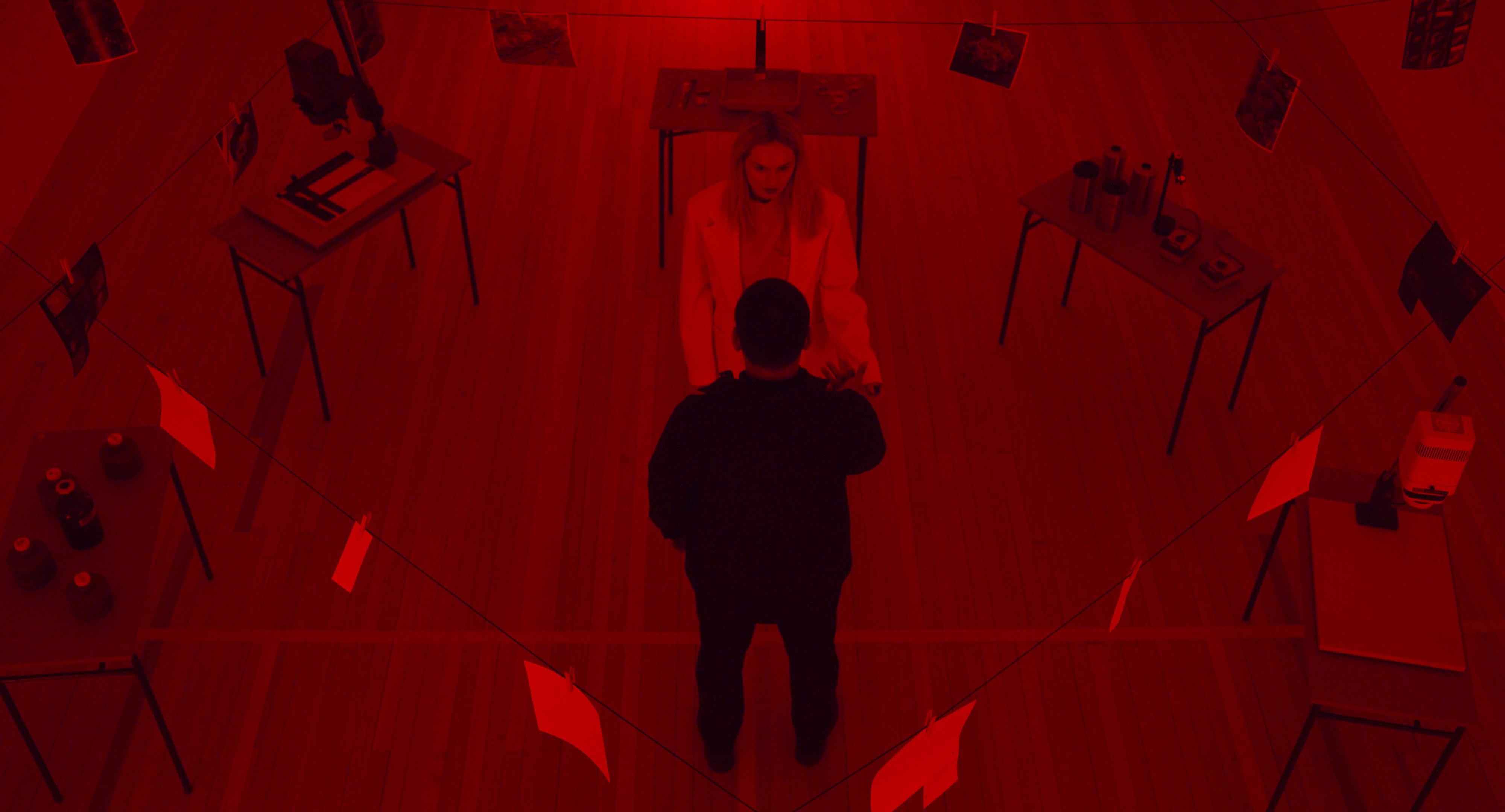 An image of two characters communicating with each other in an entirely red room.  