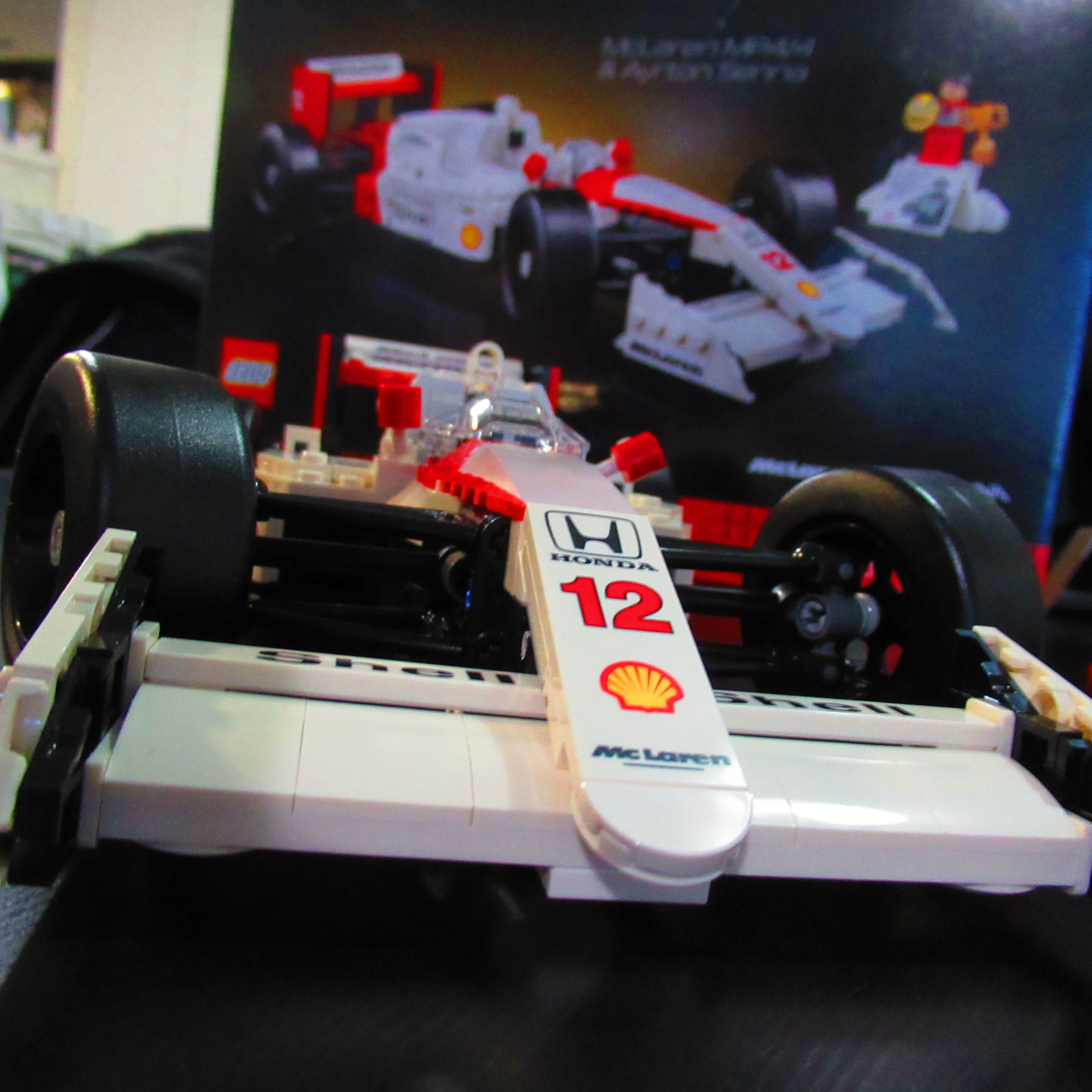Completed Ayrton Senna & MP4/4 Lego set from a front on view with box in background.