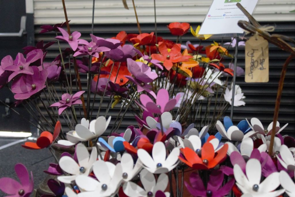 Metal garden flowers displayed in vases