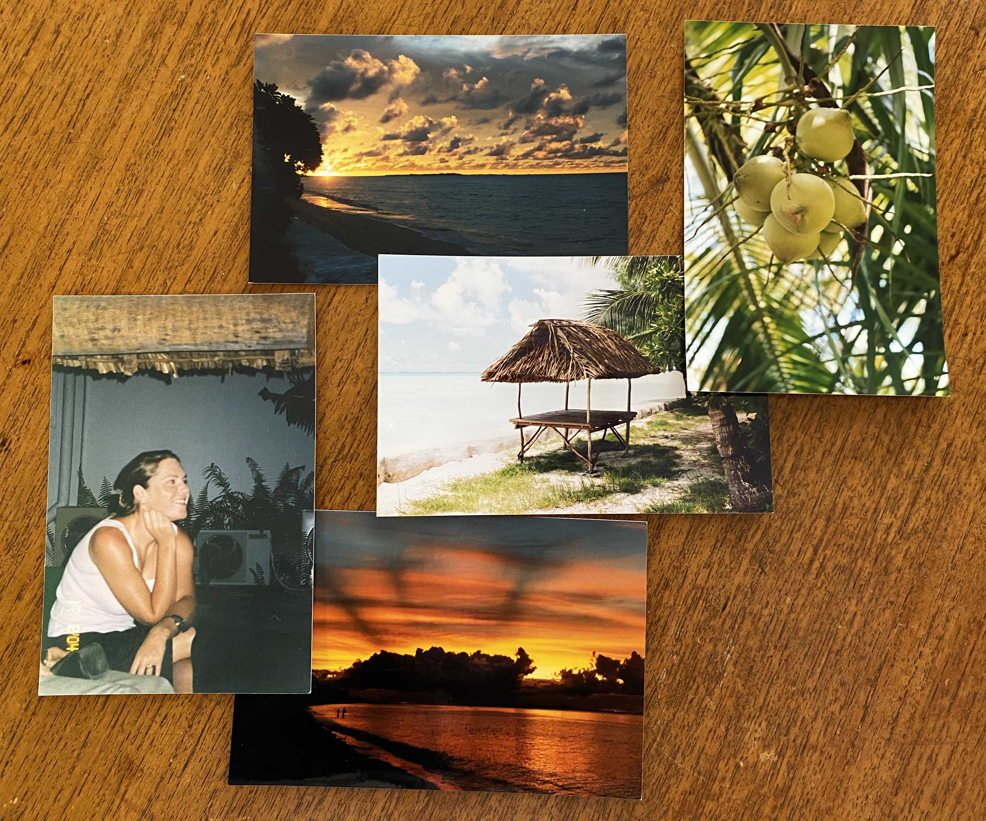 A photo of overlapping old photographs from Mel's time in Kiribati. One is of a young Mel sitting inside a Kikeya, two photos showing the Kiribati shoreline at sunset, a photo of a Kikeya from the outside, and some coconuts growing on local Kiribati trees.