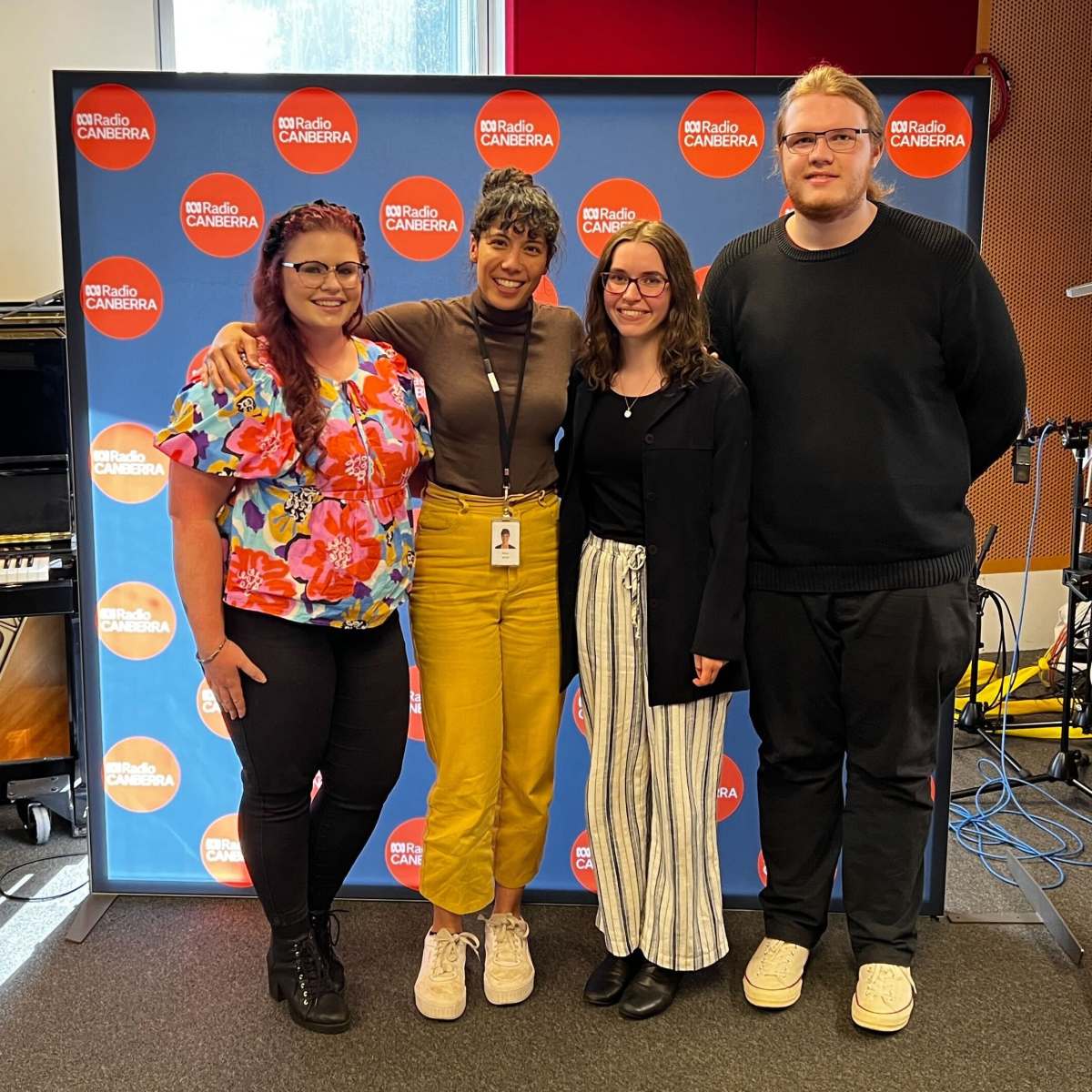 Lila, Tia and Ben posing in the ABC Canberra studio with Alice Matthews