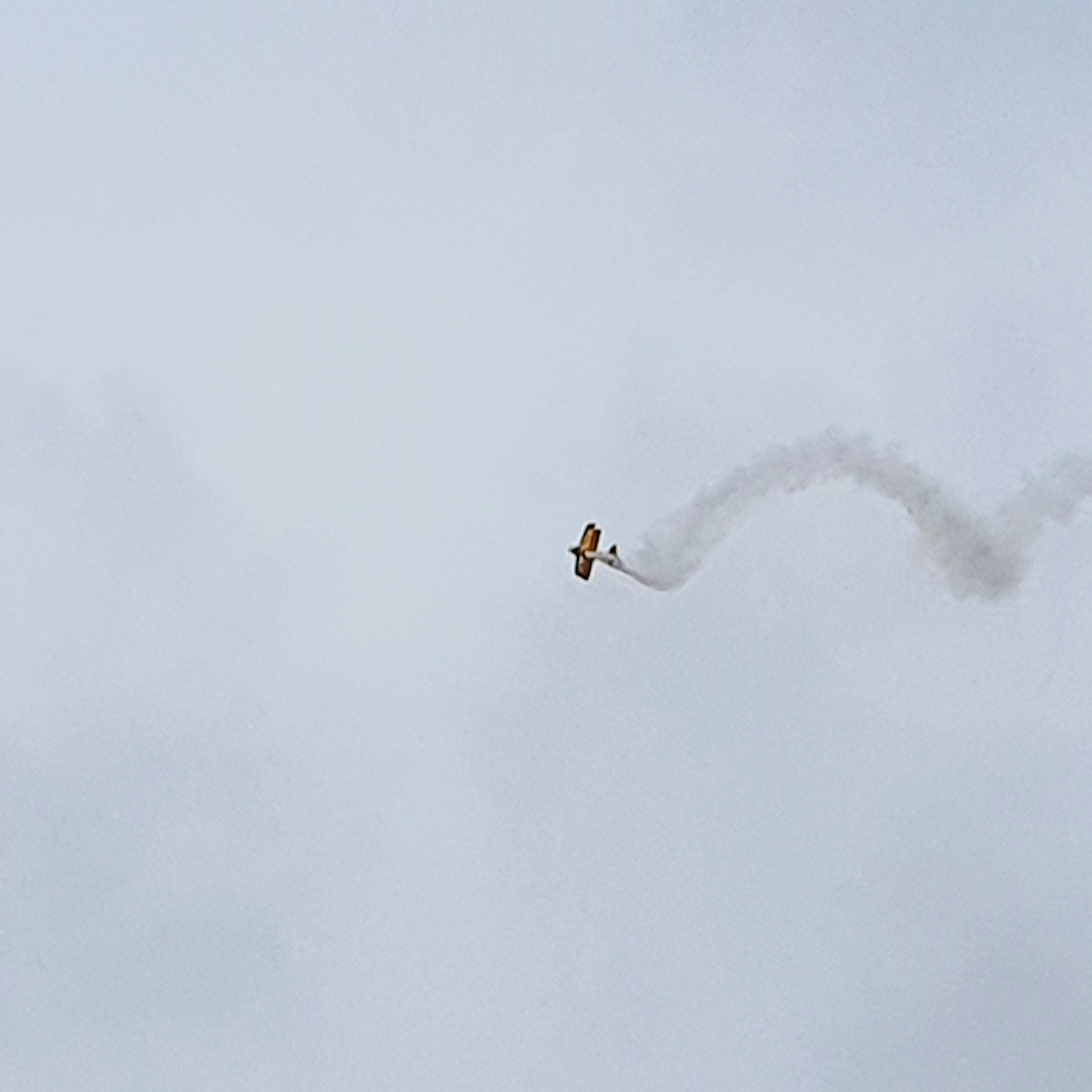 Plane doing aerobatics in the air.