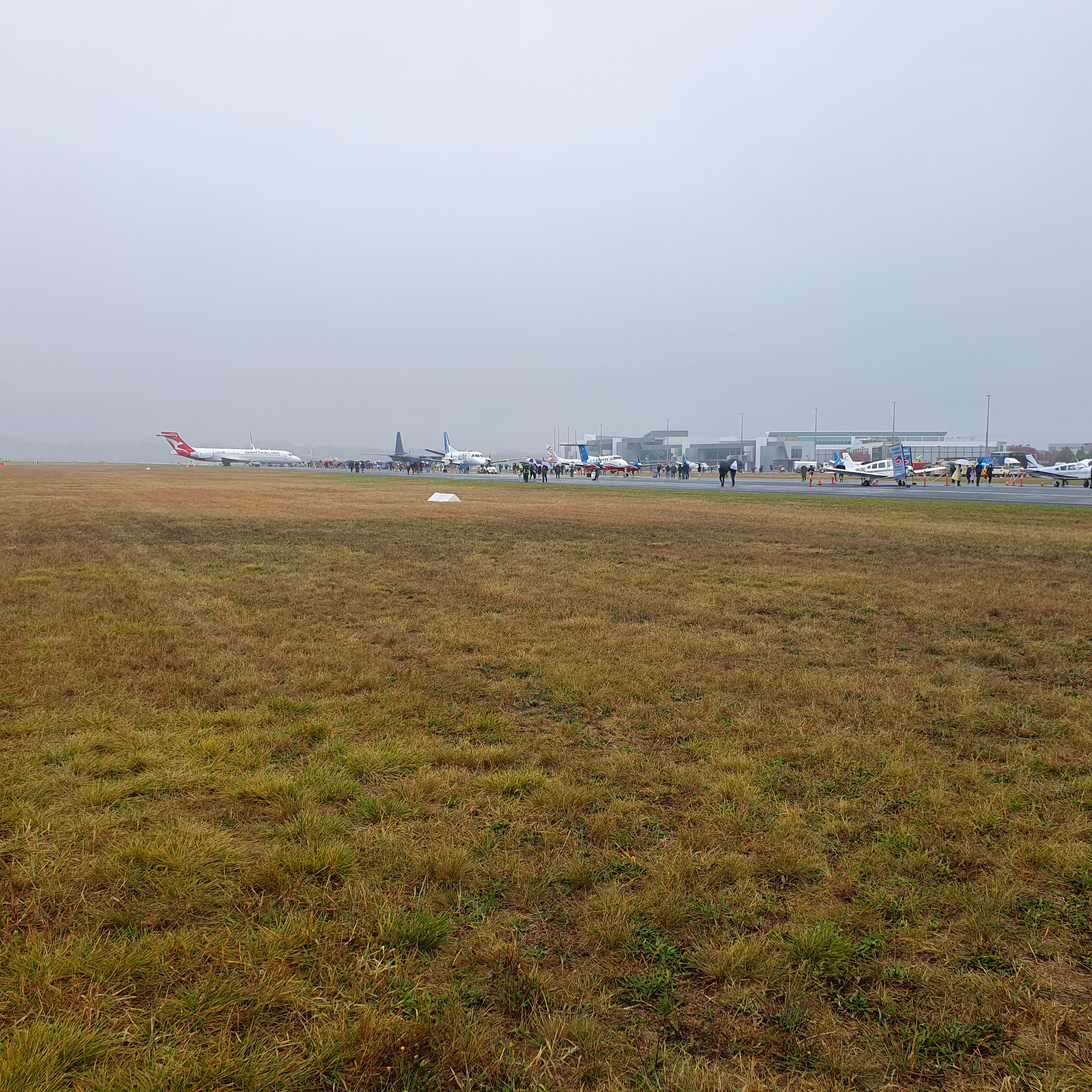 Extreme wide shot of the airports airstrip with planes.