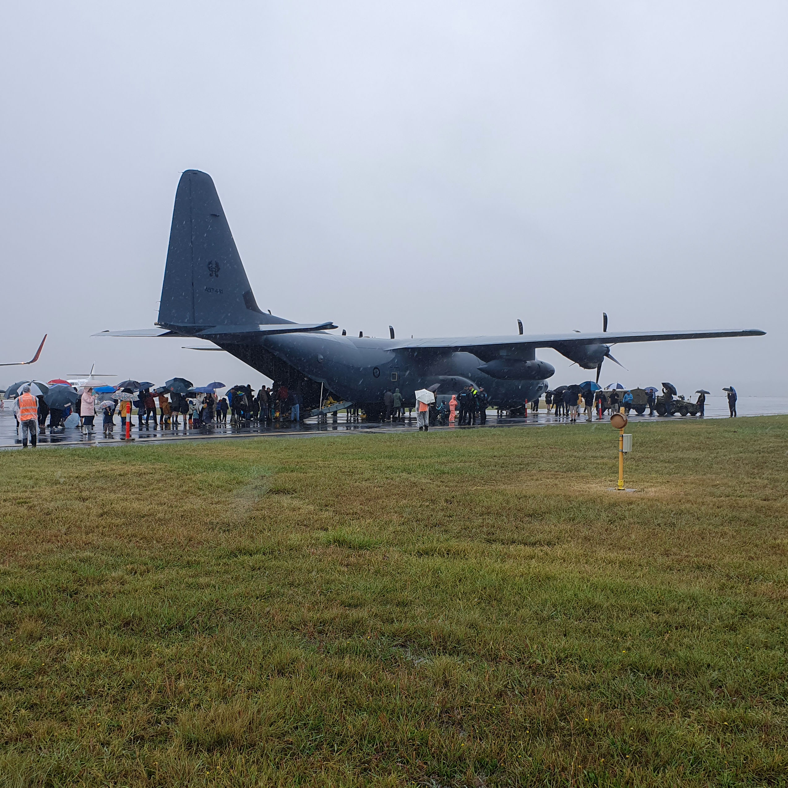People lining up to board and tour the C-130J Hercules.