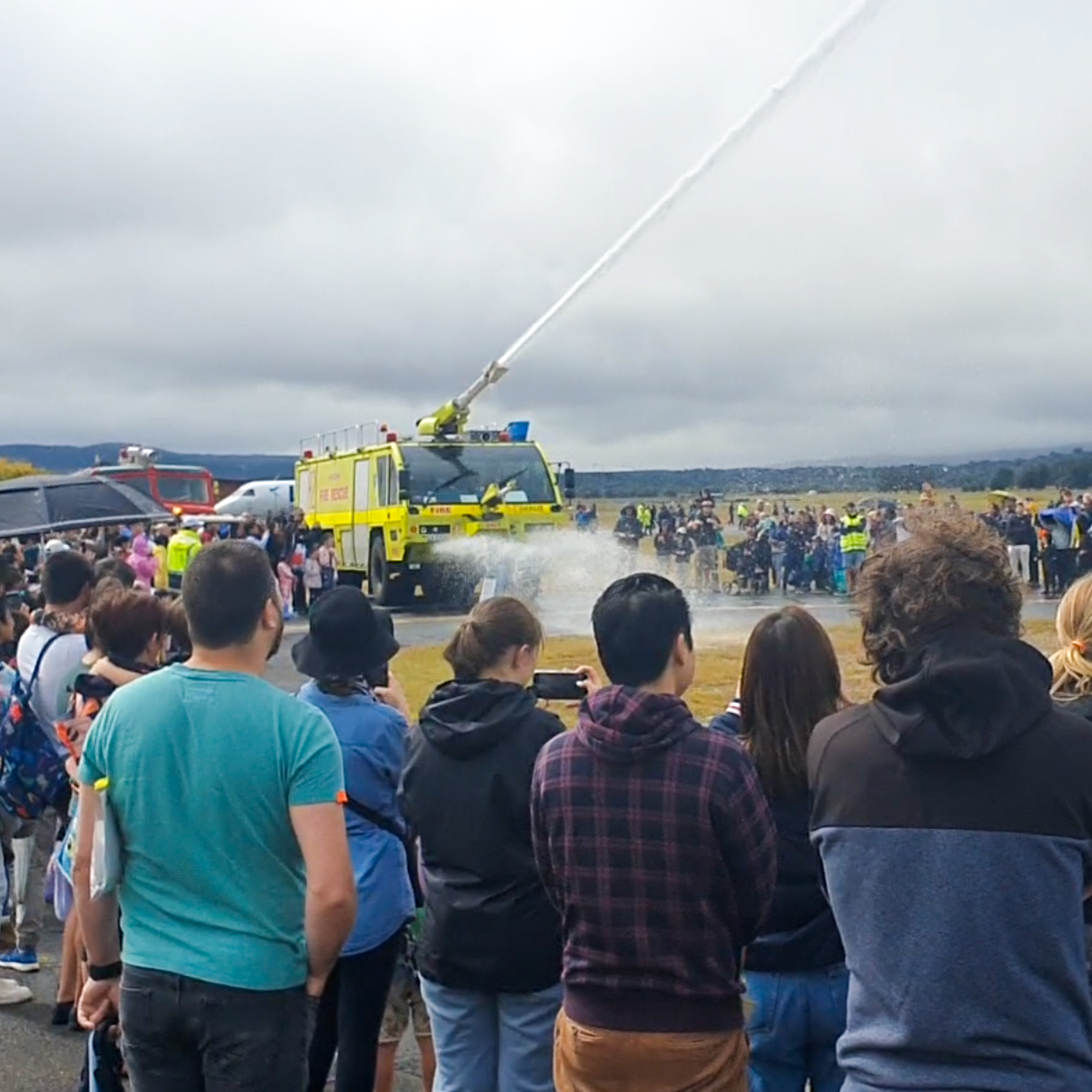 Aviation fire rescue vehicle doing a water display.