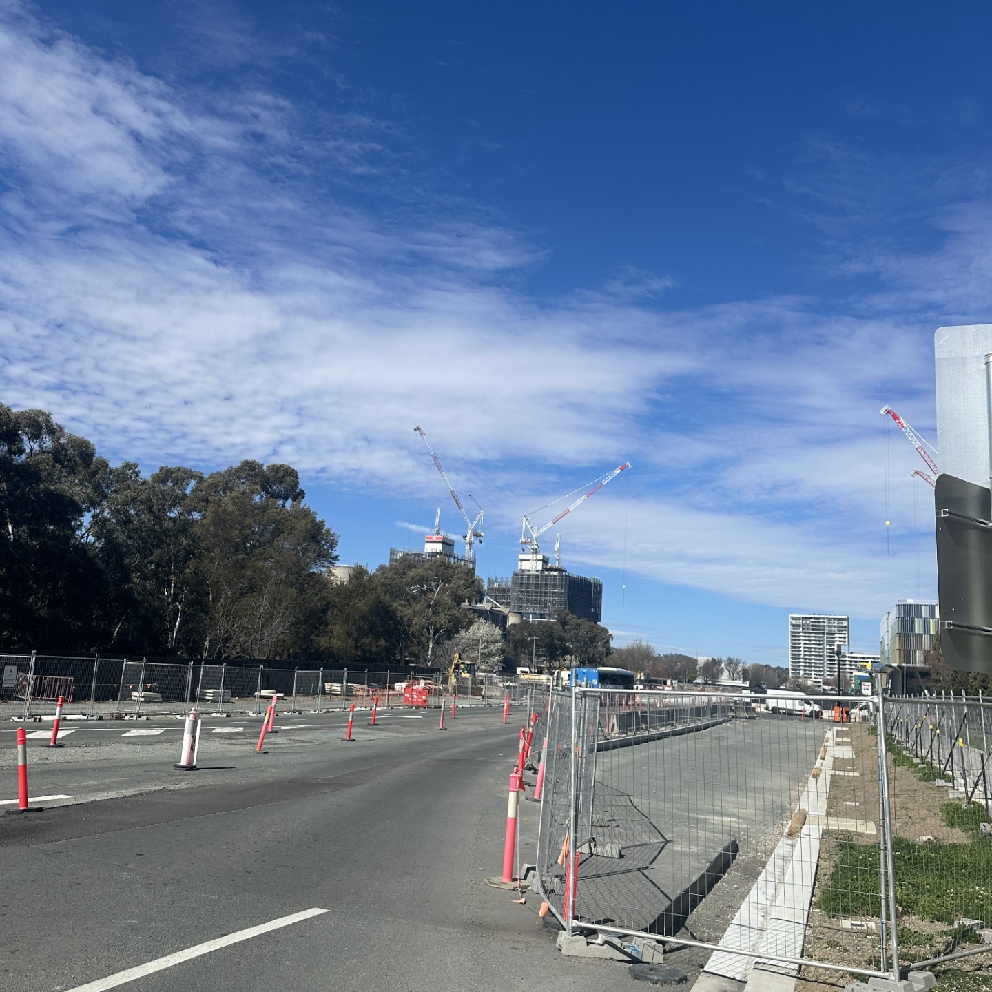 Photo shows construction underway at Woden, to allow for the light rail. Construction fencing and markers are visible. 