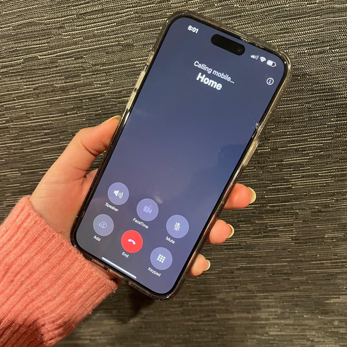 a person holding a phone calling 'home'