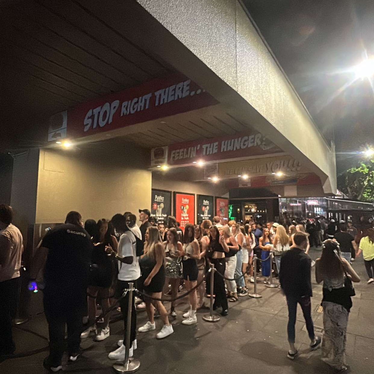 Image shows crowds lined up outside of a Canberra club 'Fiction'. 