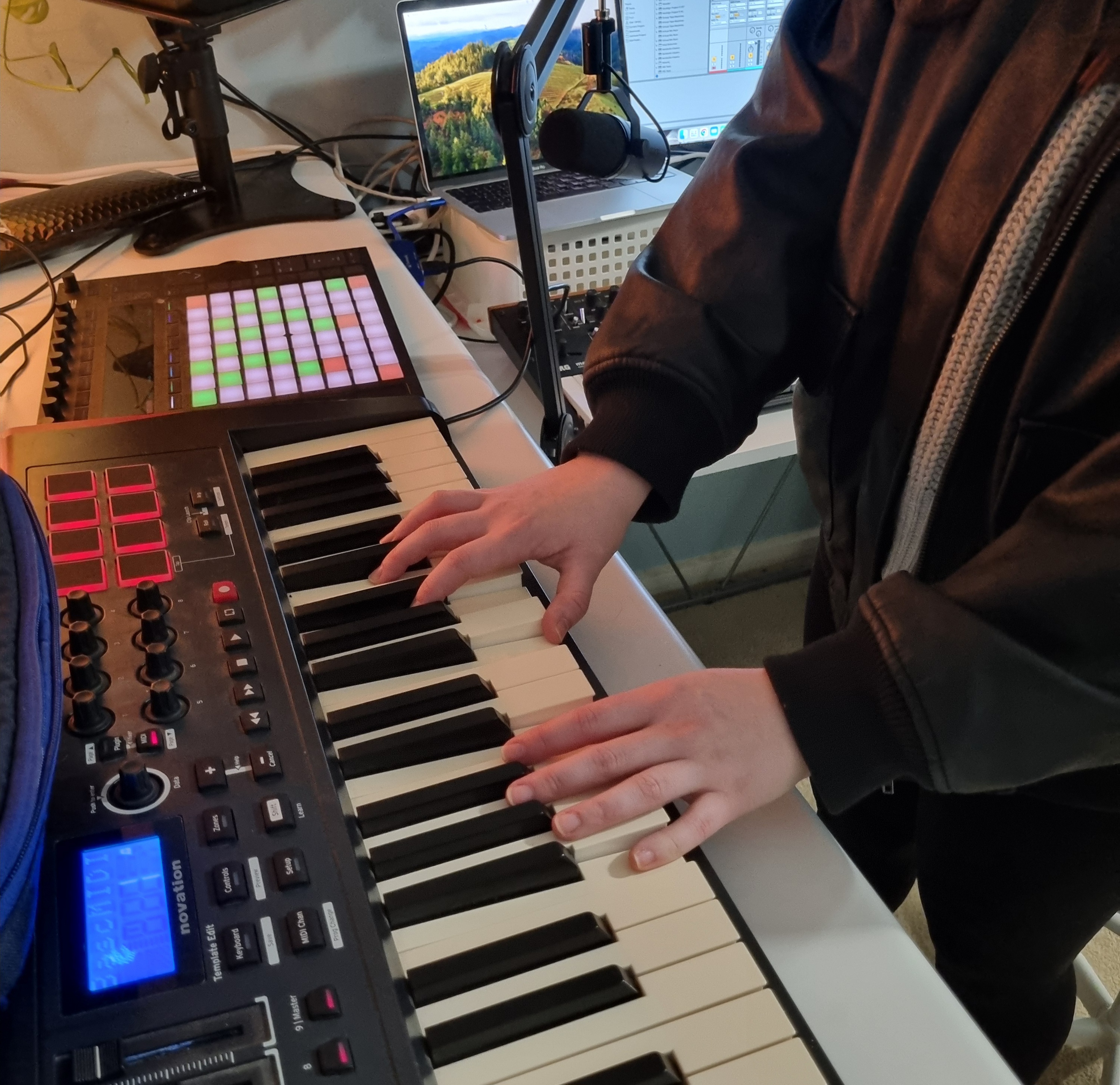 Sophie's hands playing on a keyboard connected to a soundboard