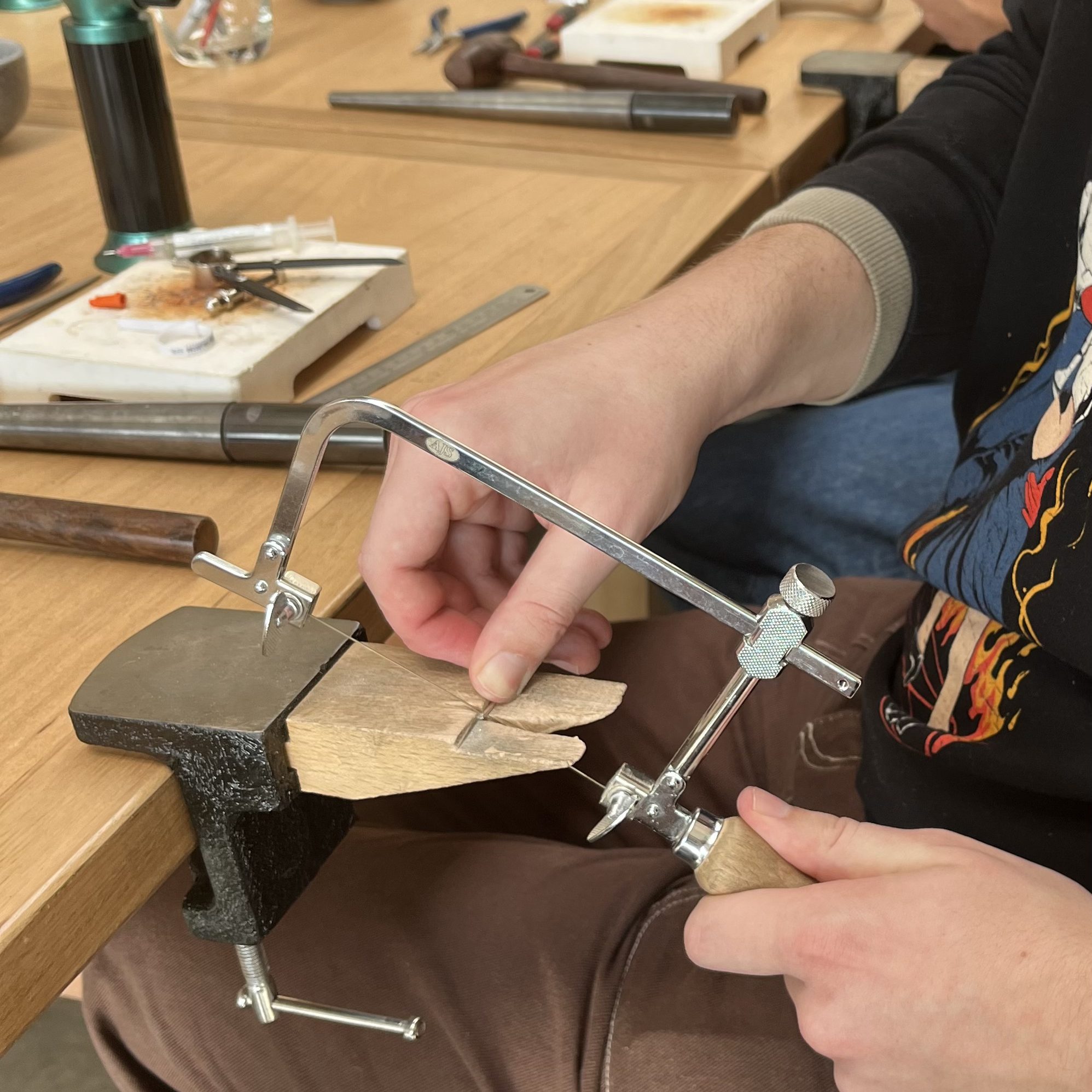 Sawing of metal in. class