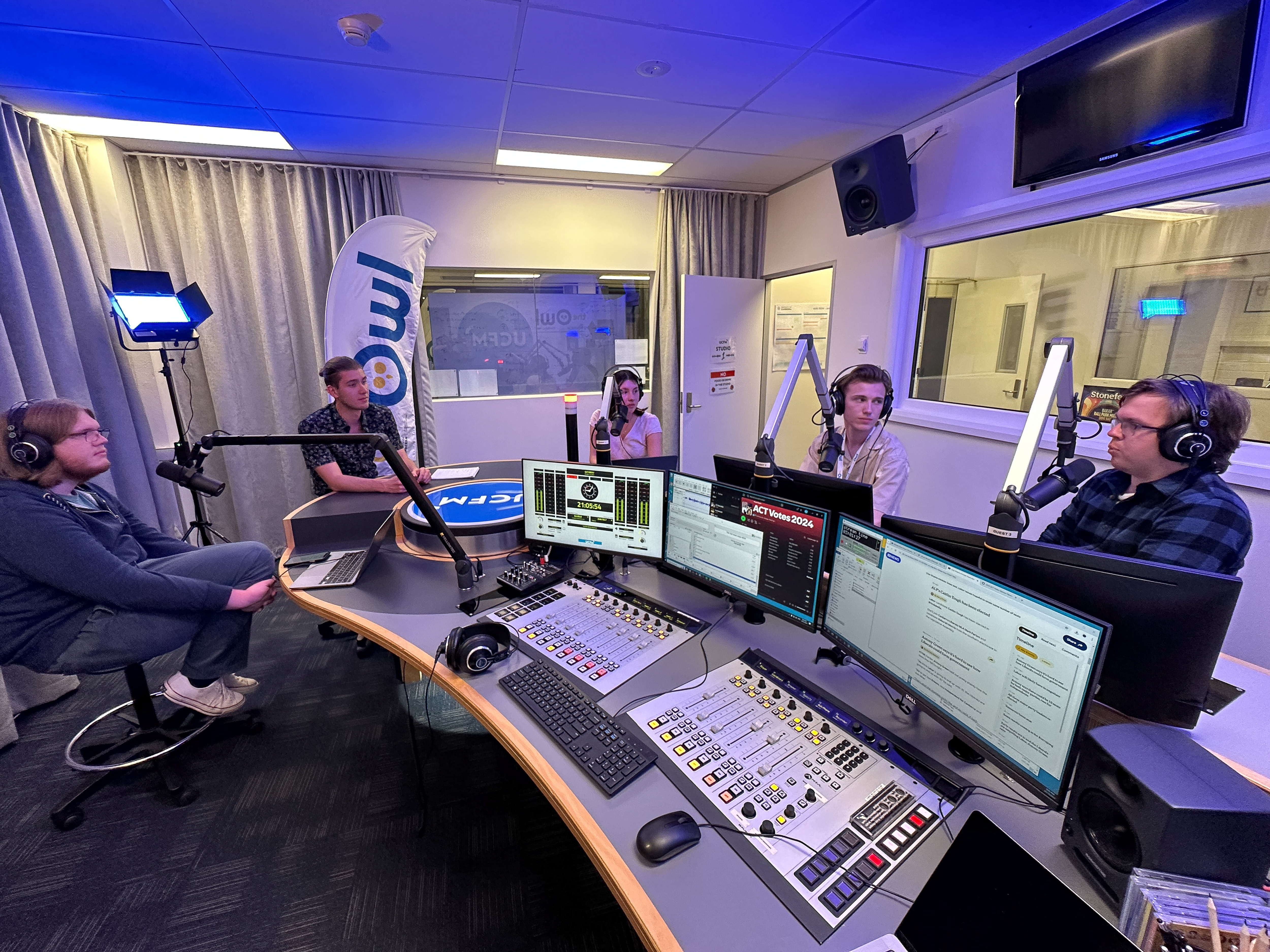 The Election Newsroom team sitting behind mics in the UCFM studio