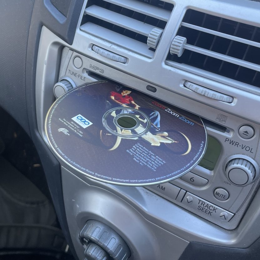 Mazda Mixtape CD partially in a cars CD player