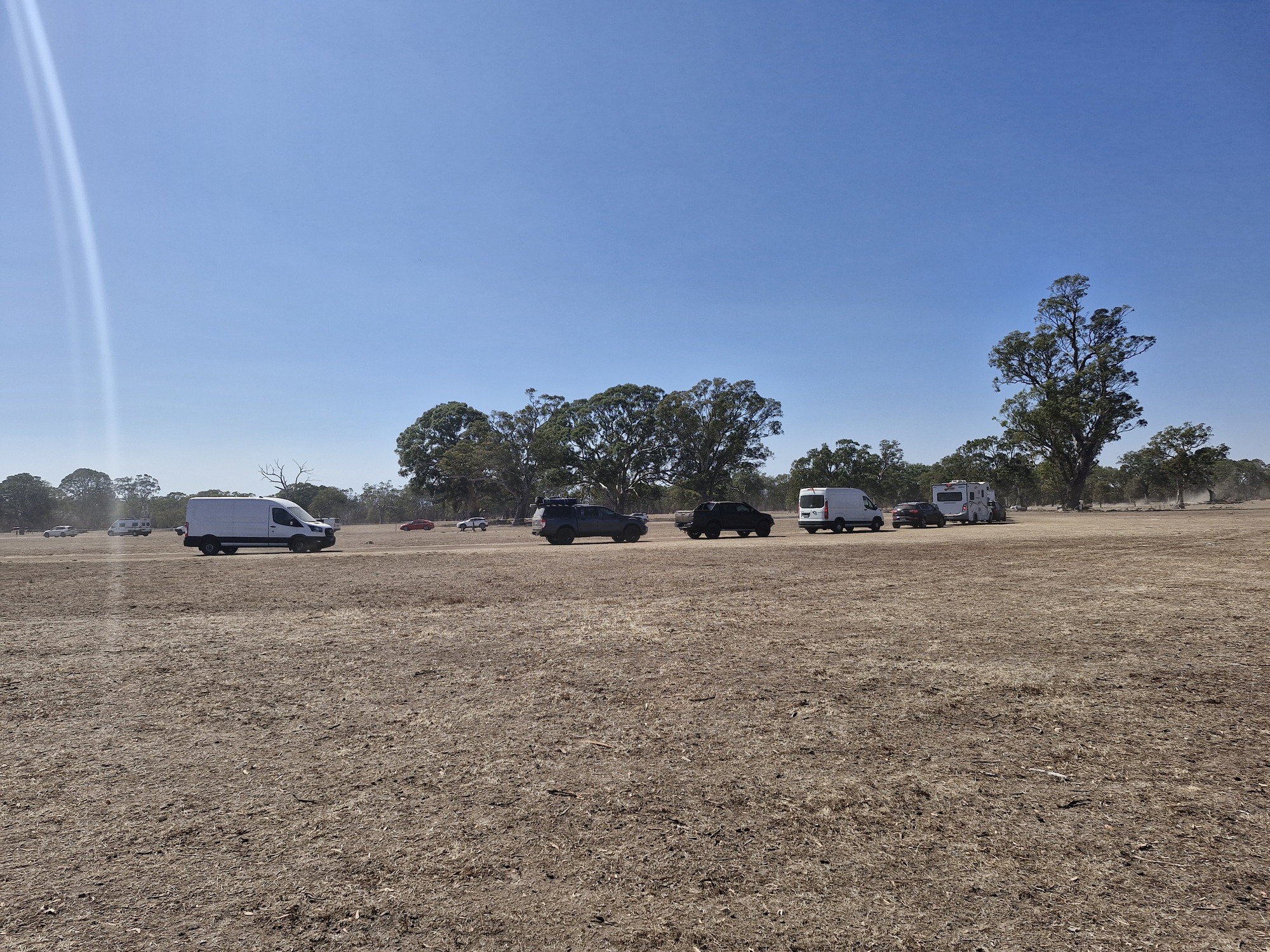 Cars travelling on dirt road