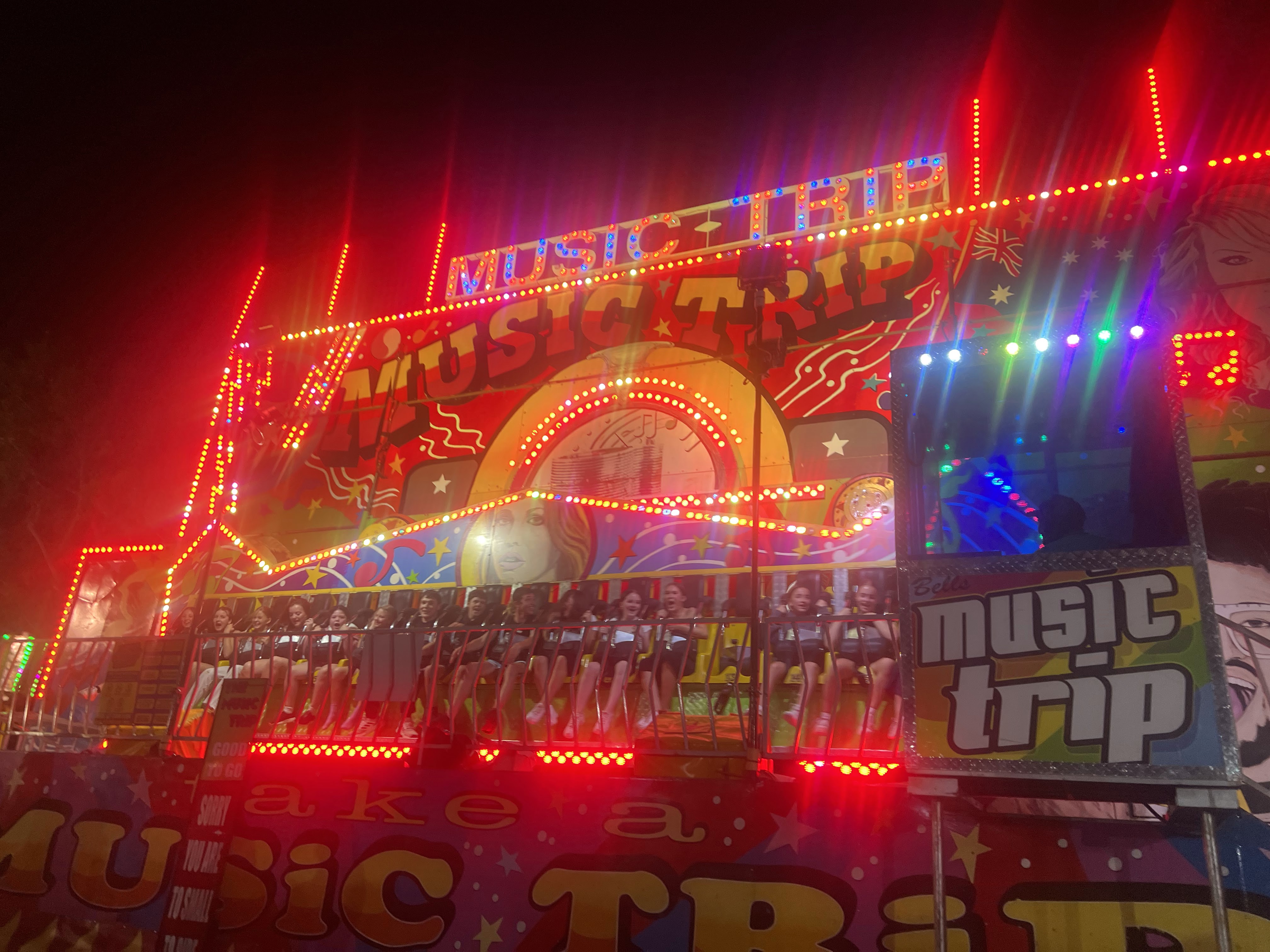 The "music trip" carnival ride with patrons strapped into the seats ready
