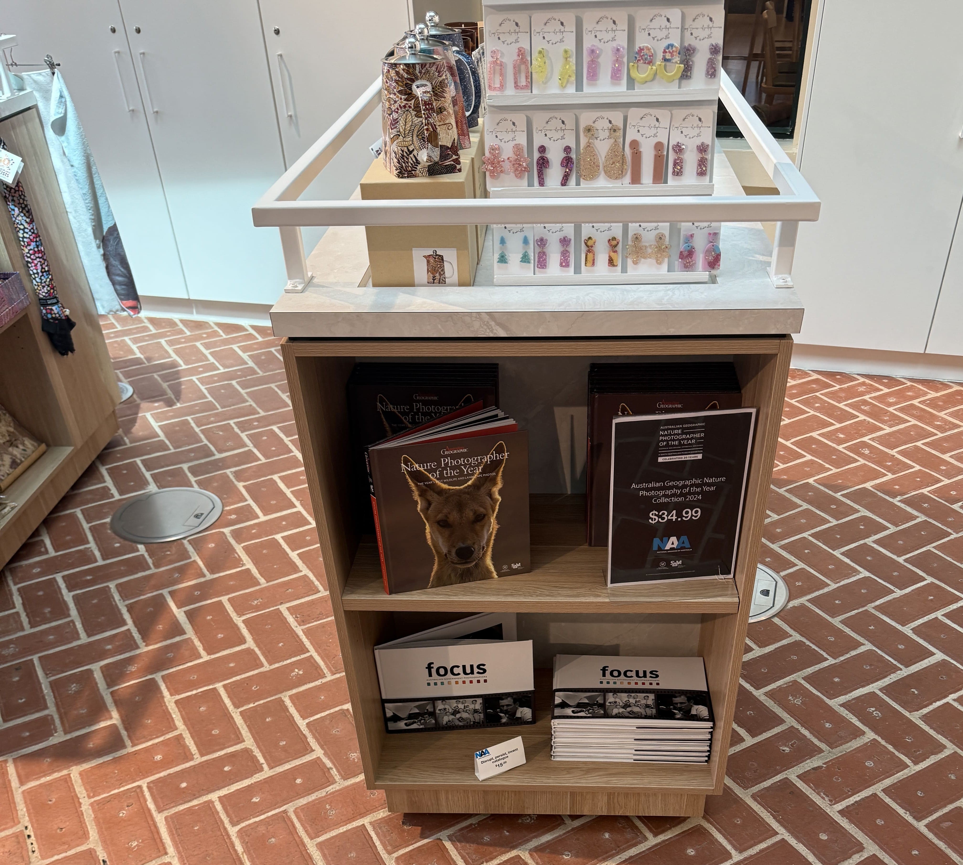 Gift shop at the entrance of the exhibition, featuring a range of themed goods, such as books keyrings and mini led-light product.