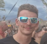 Man wearing sunglasses smiling at camera