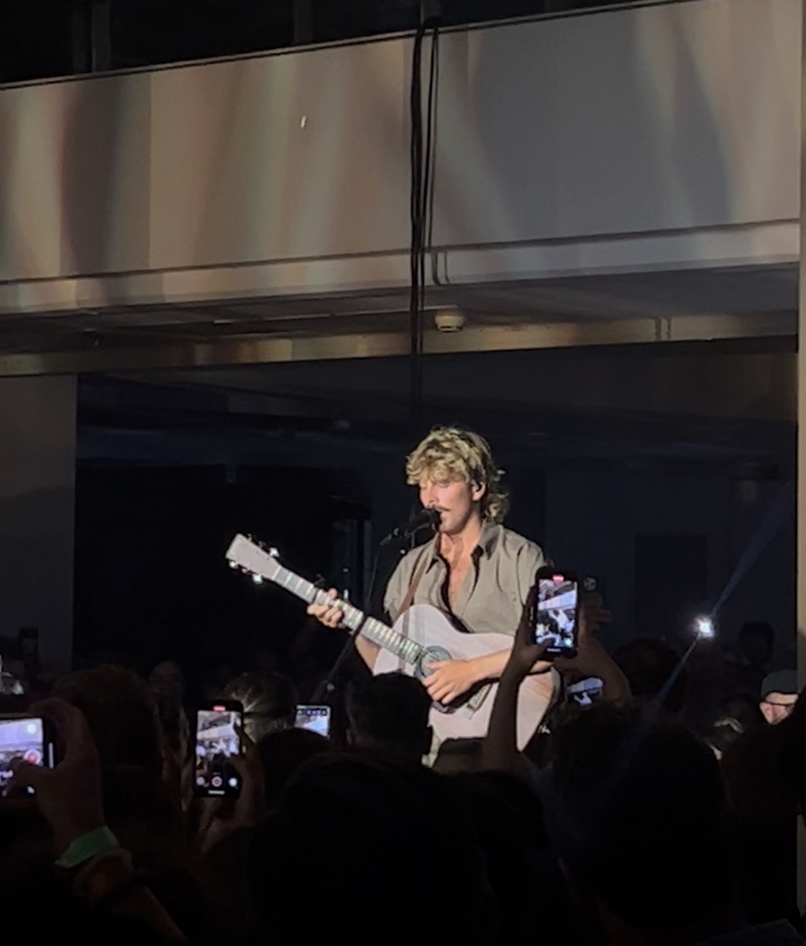 Ziggy Alberts, the headline act, playing guitar on the B stage.