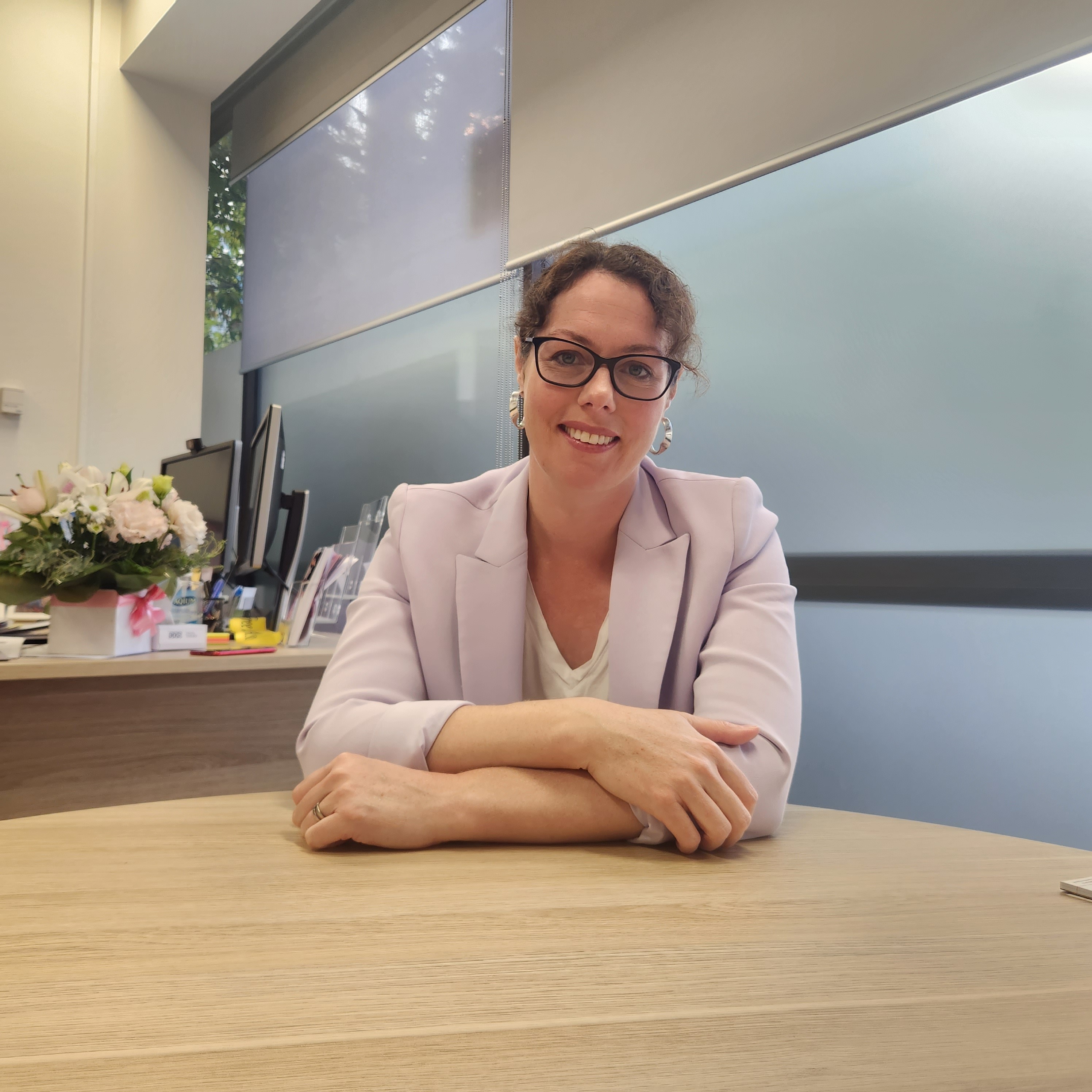 MP Alicia Payne sitting at a desk inside her electoral office
