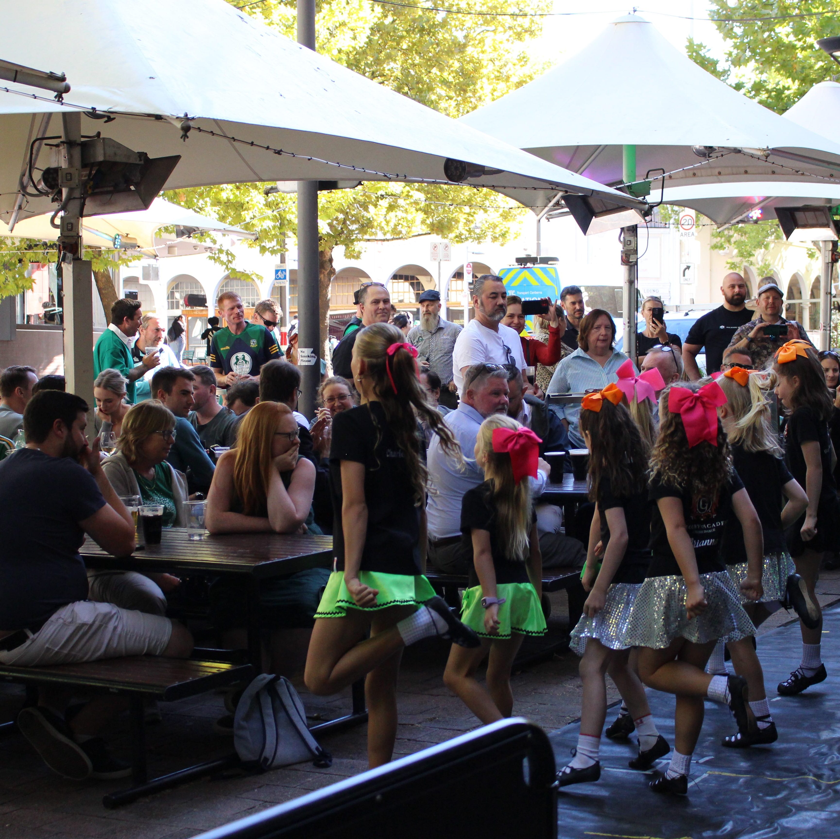 Younger group of Irish dancers perform in front of the outside crowd.