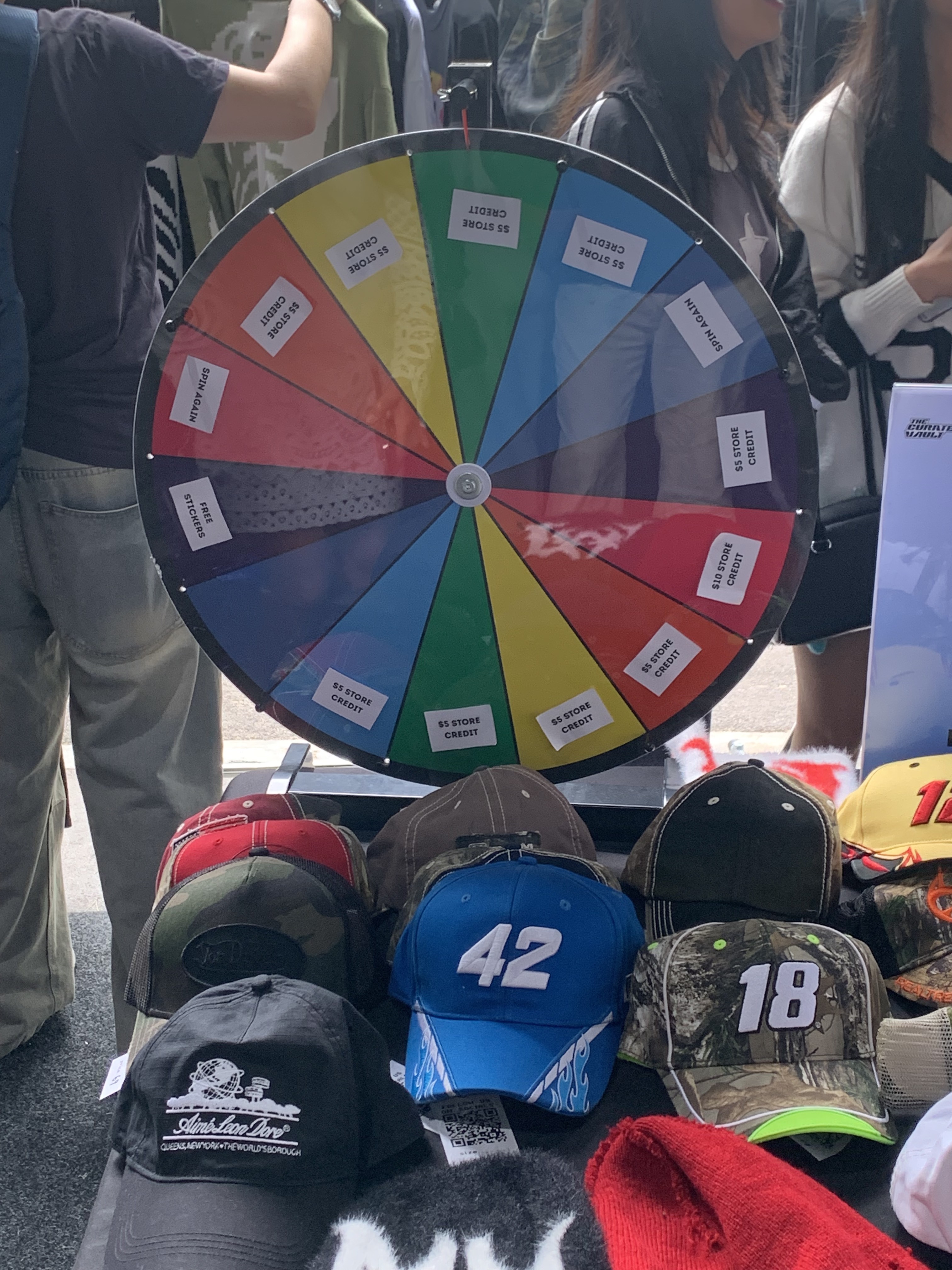 Fun coloured spin-wheel with hats on display