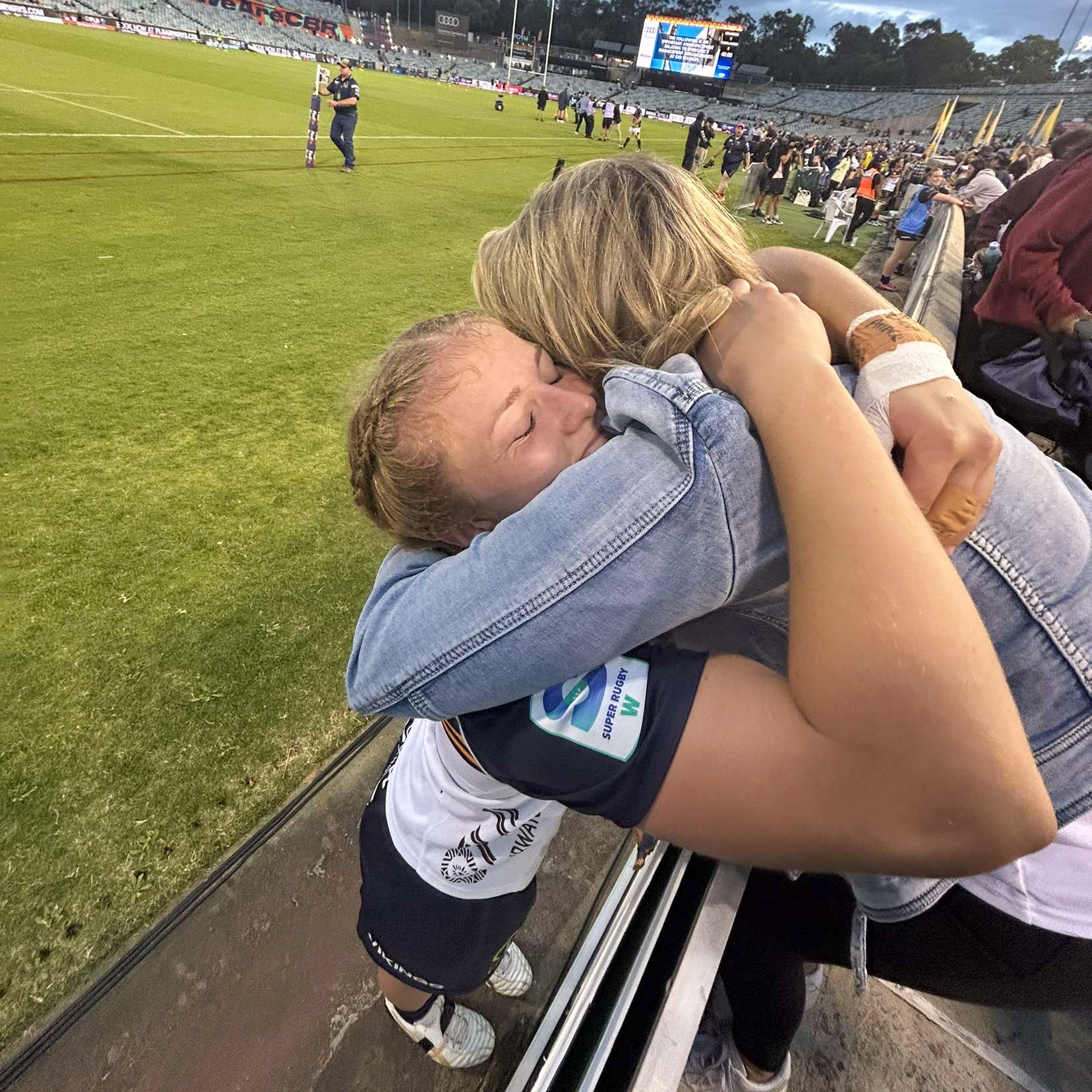 Lily bine hugging her mum on the field post match.