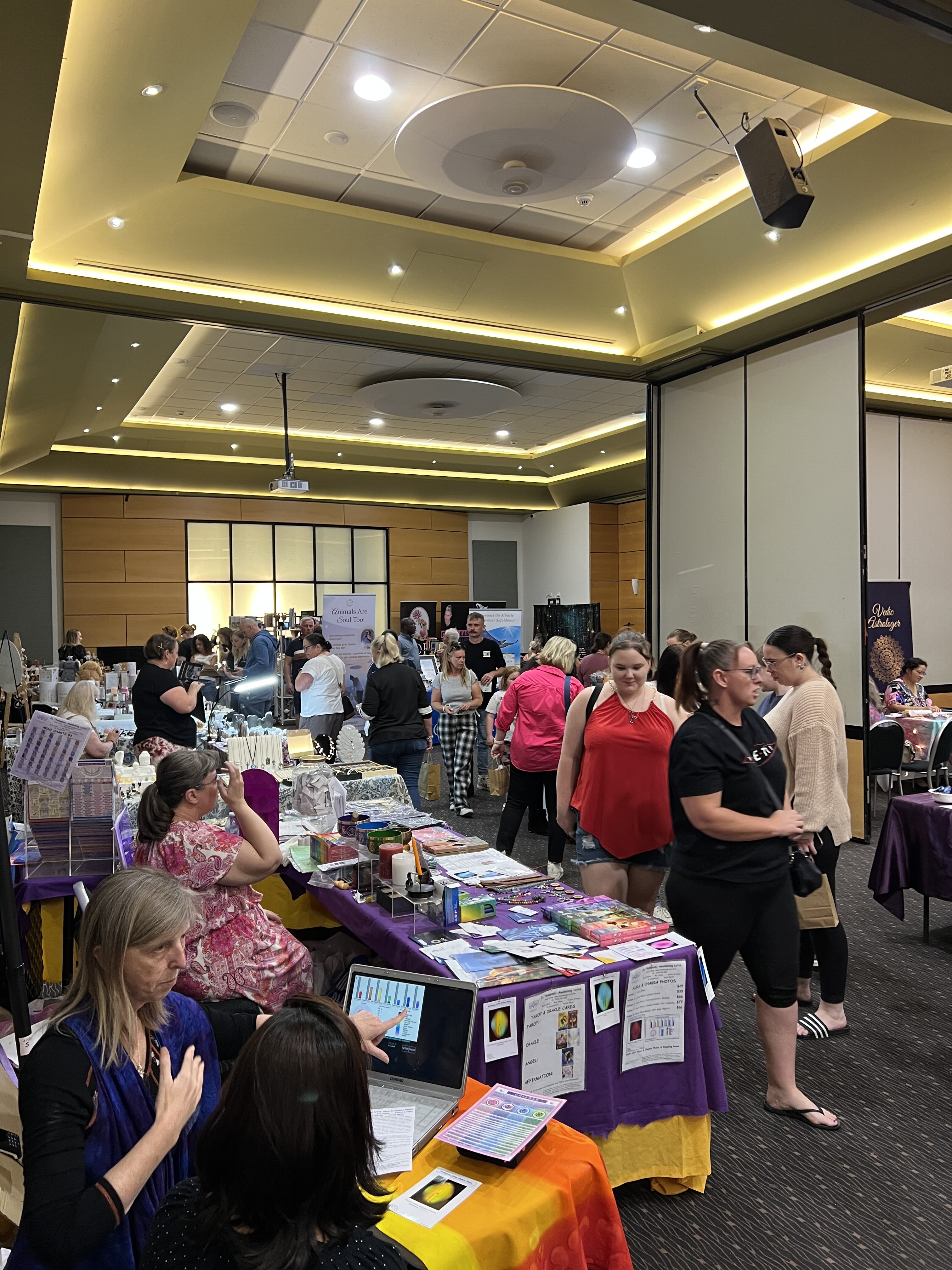 Crowd walking through function space with lots of vendors