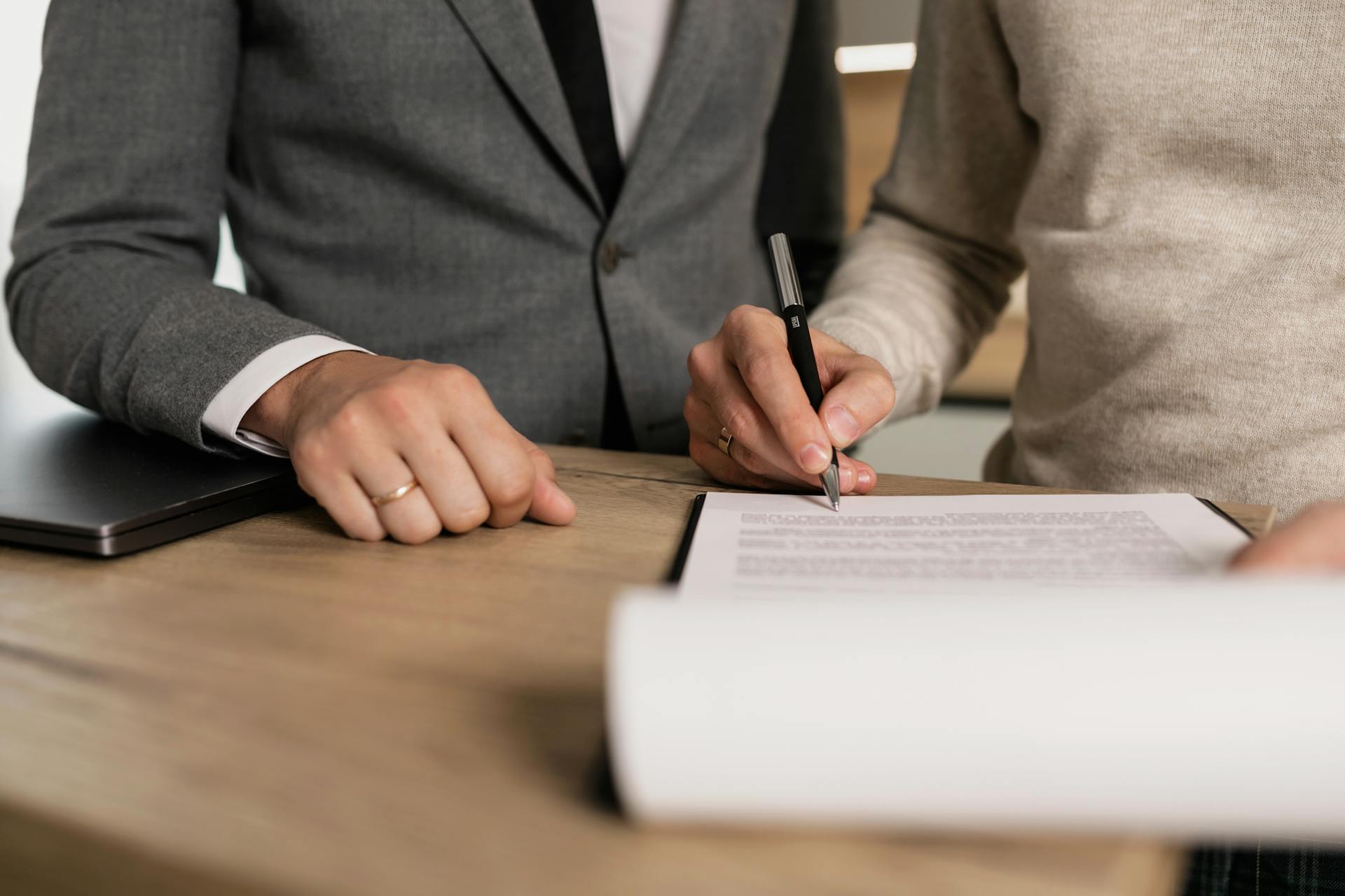 Two individuals sign a contract
