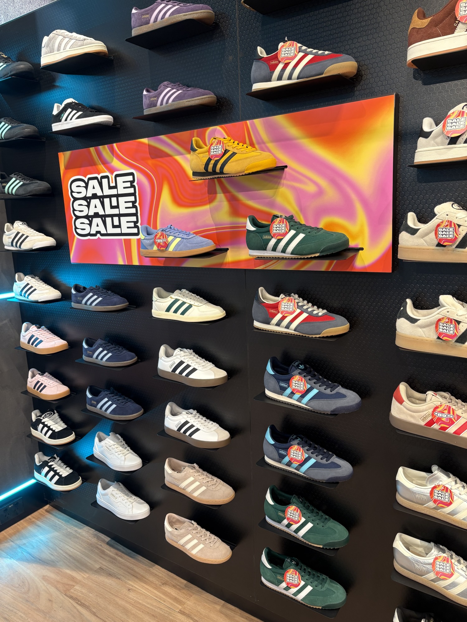 Photograph of adidas shoes on shoes wall 