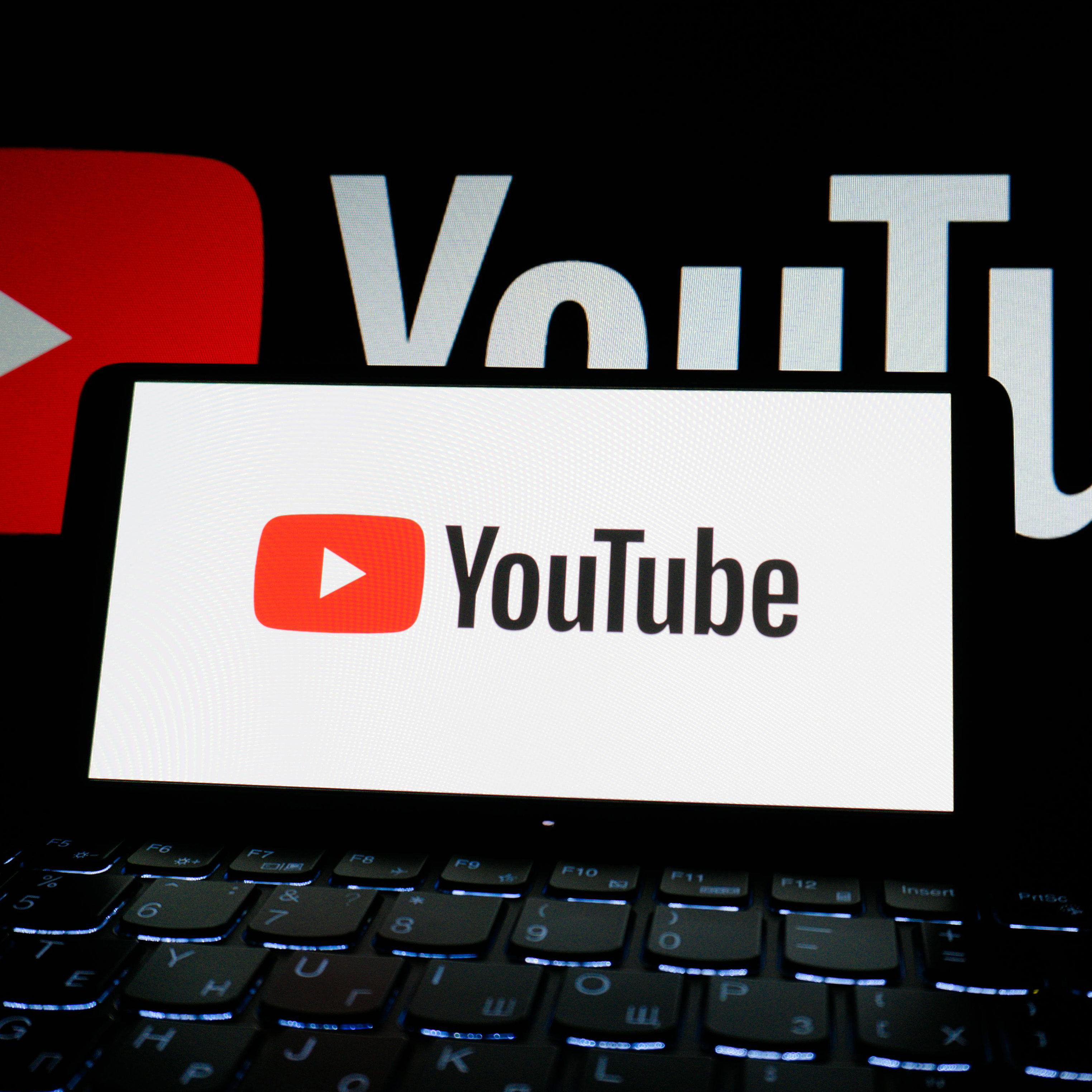 Phone with YouTube open in a dark setting.