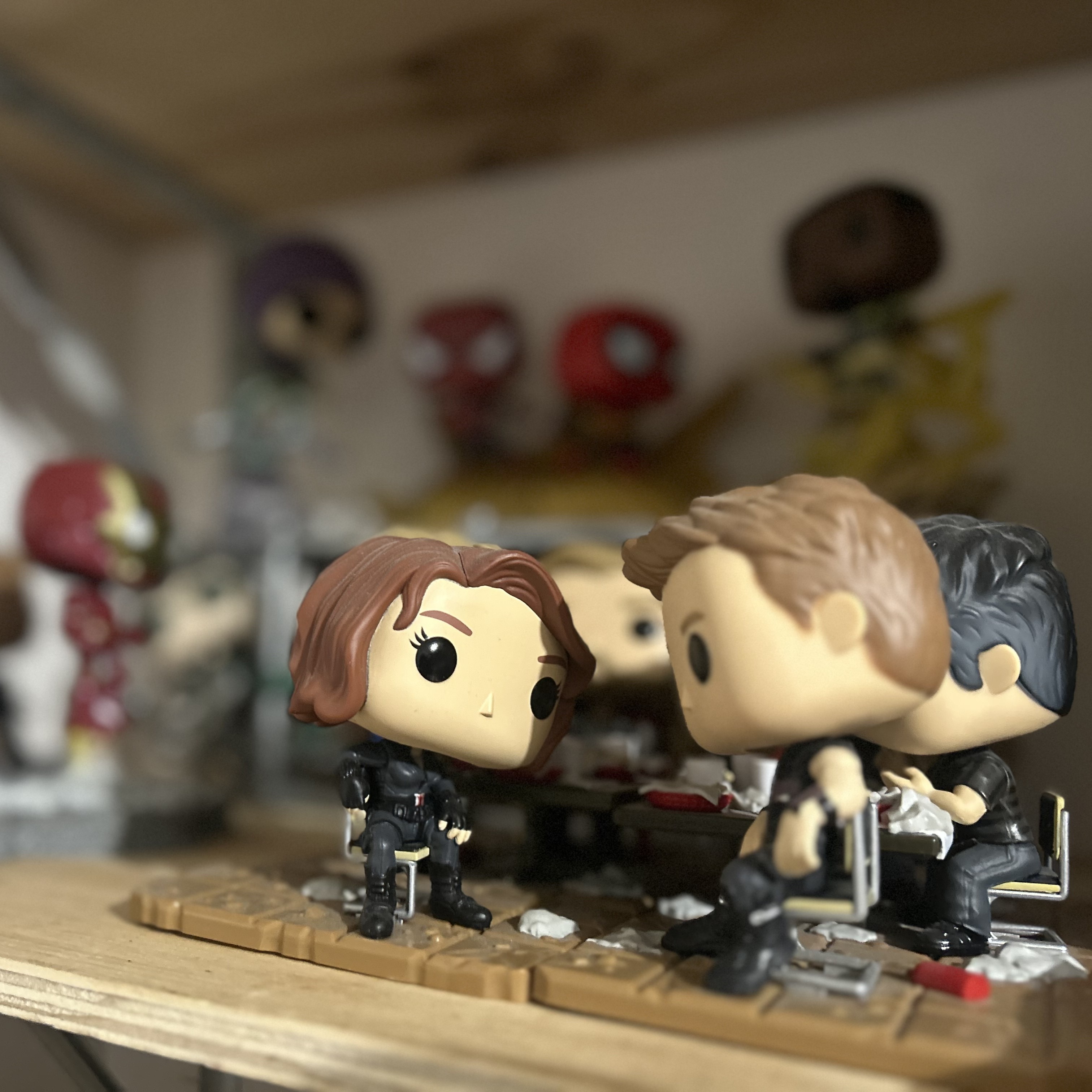 Pop vinyl figures sitting around a table