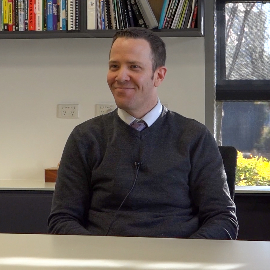 Jacob Knowles sitting and smiling.