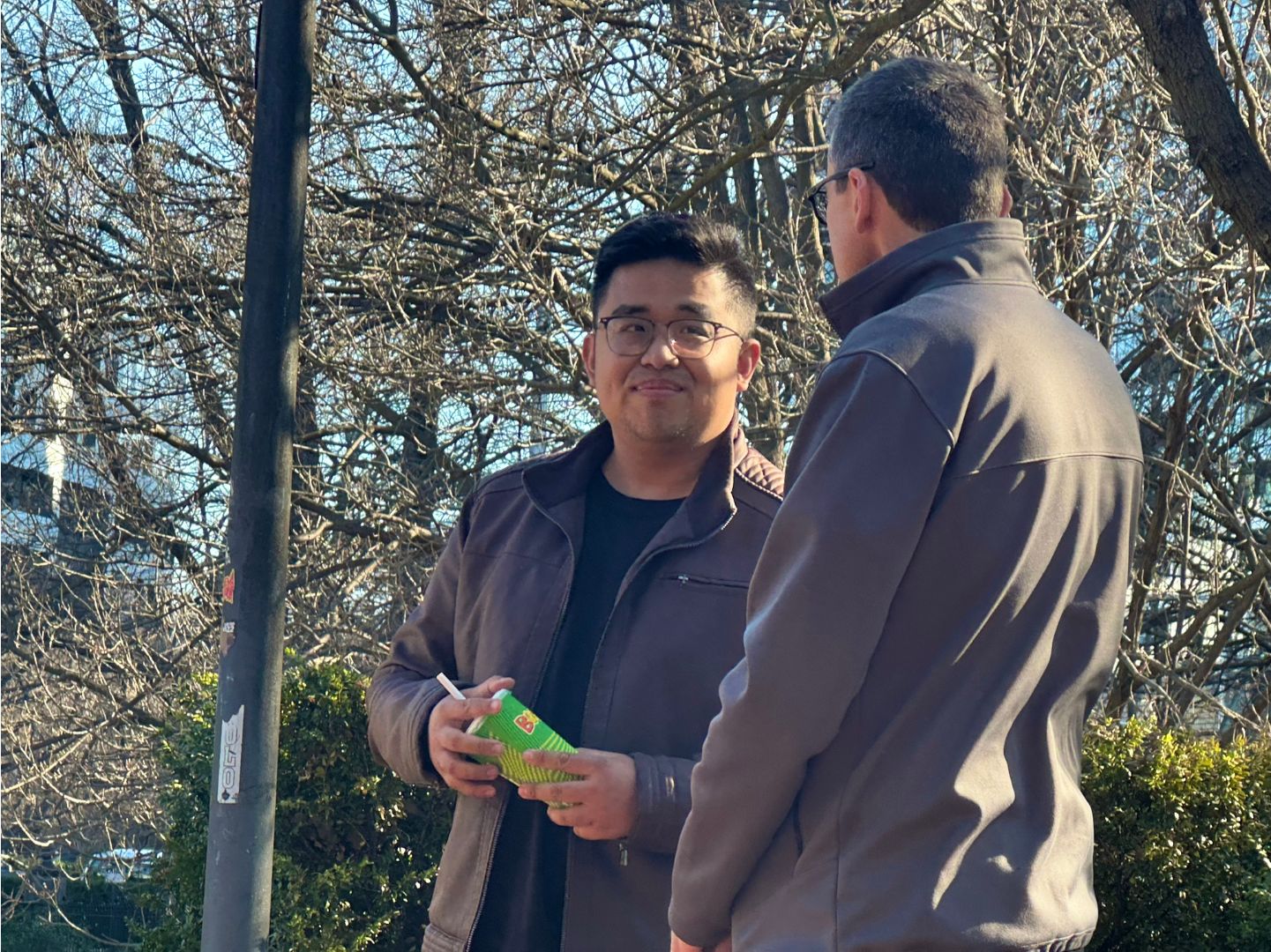 Two people talking to each other outdoors.