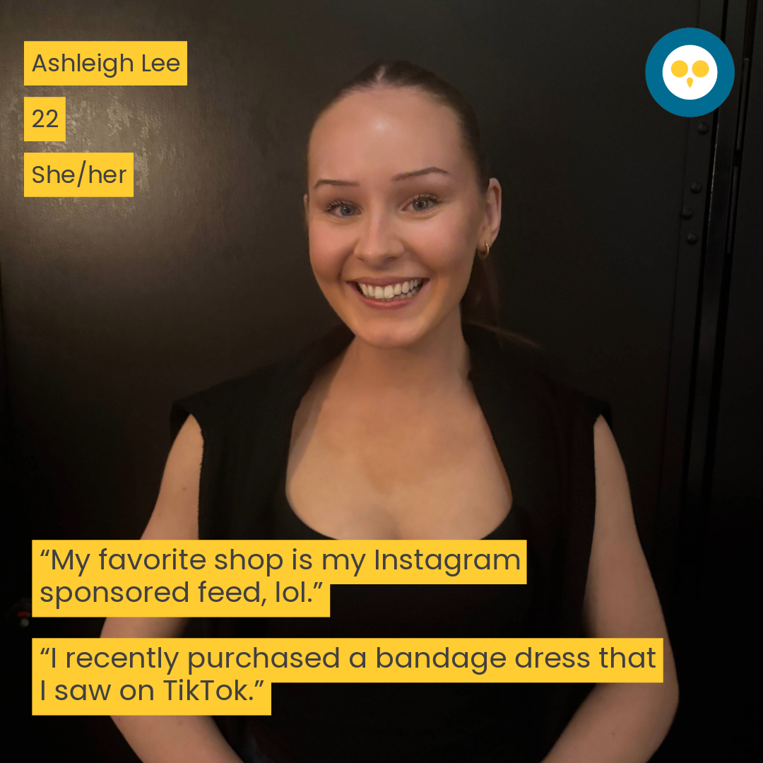 woman standing infront of a black wall, smiling