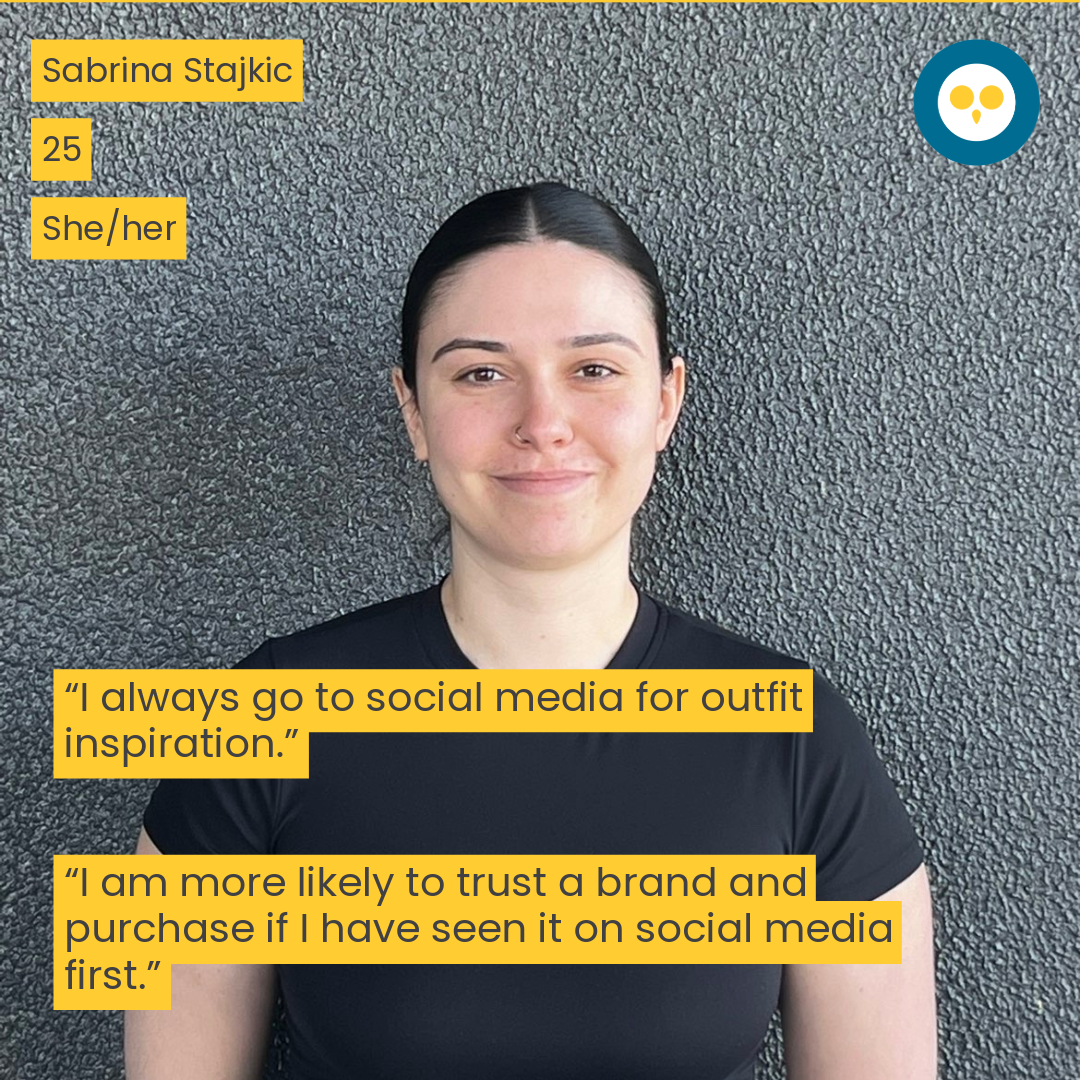 woman in front of a black wall, smiling 