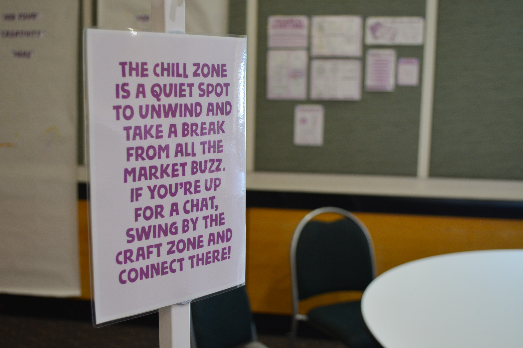 A sign posted outside the the market's 'chill zone', reading "The chill zone is a quiet spot to unwind and take a break from all the market buzz. If you're up for a chat, swing by the craft zone and connect there!"