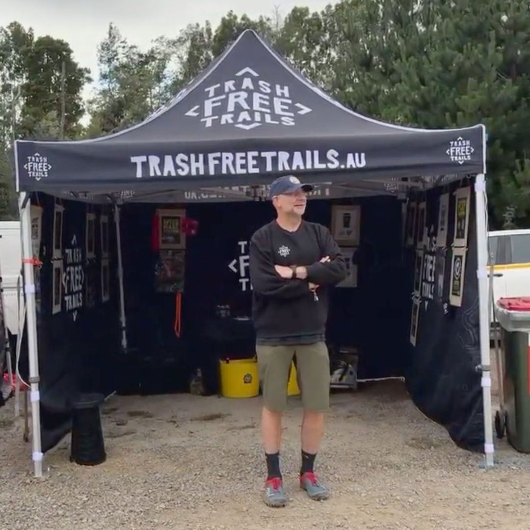 Tom Hutton standing in front of the TFT tent at the Red Bull Hardline Tasmania event expo.
