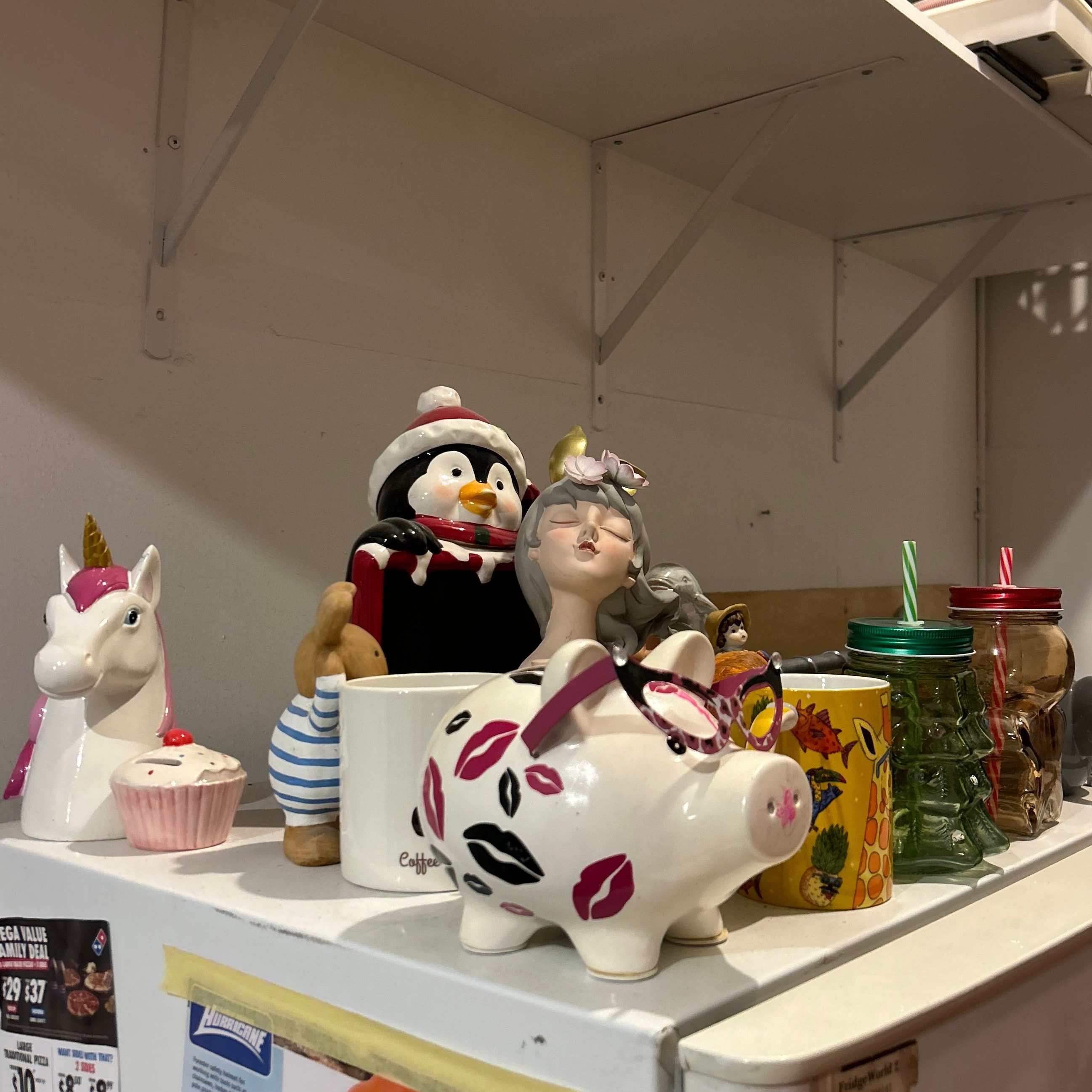 Staff fridge displaying a collection of unusual items saved from rage room sessions over time