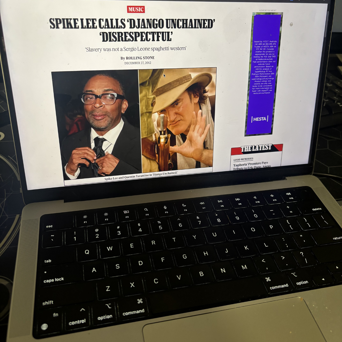 A Macbook screen which it open to a Rolling Stone article. The article is titled "Spike Lee calls 'Django Unchained' 'Disrespectful'"